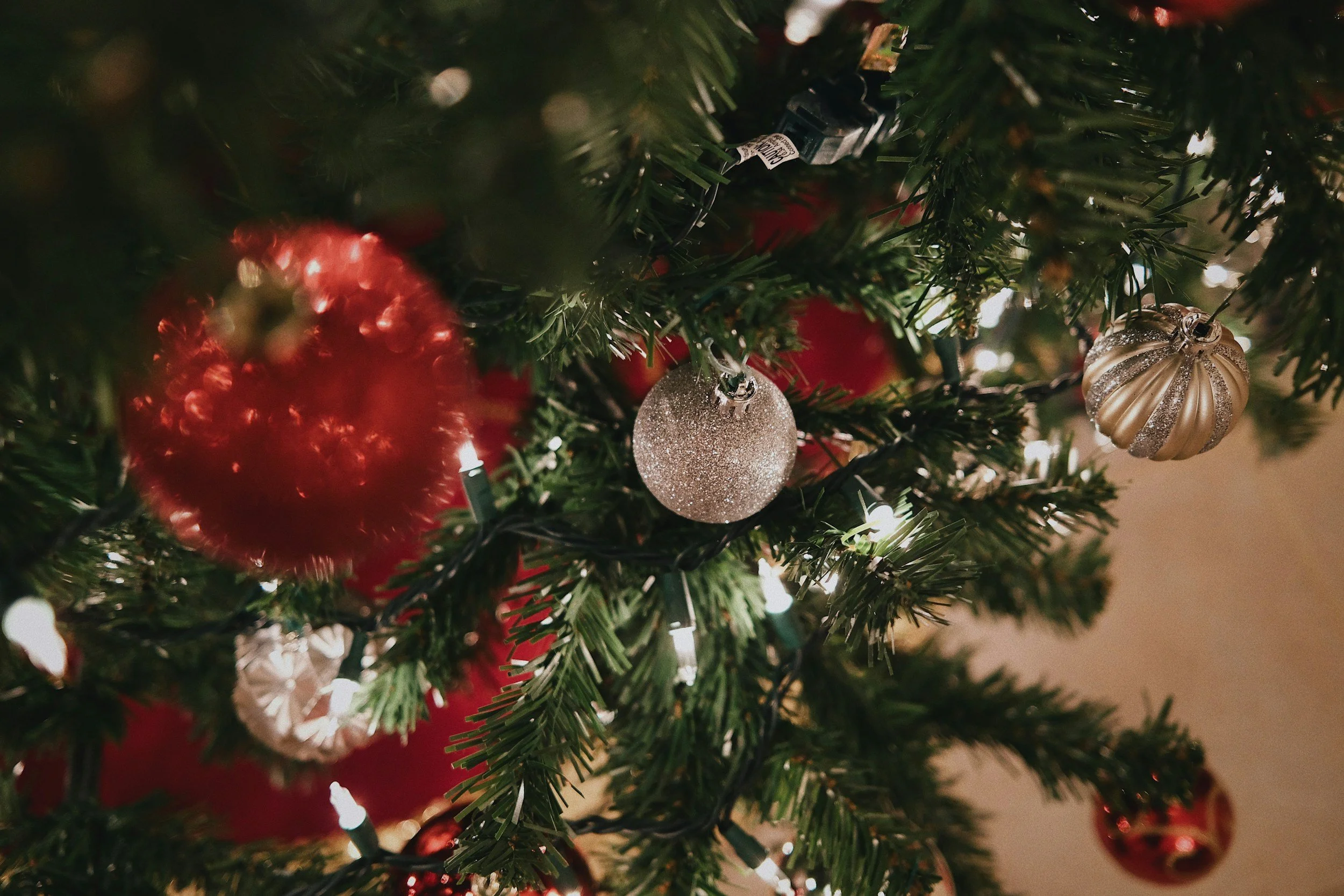 Close-up of a decorated Christmas tree with balls and lights.