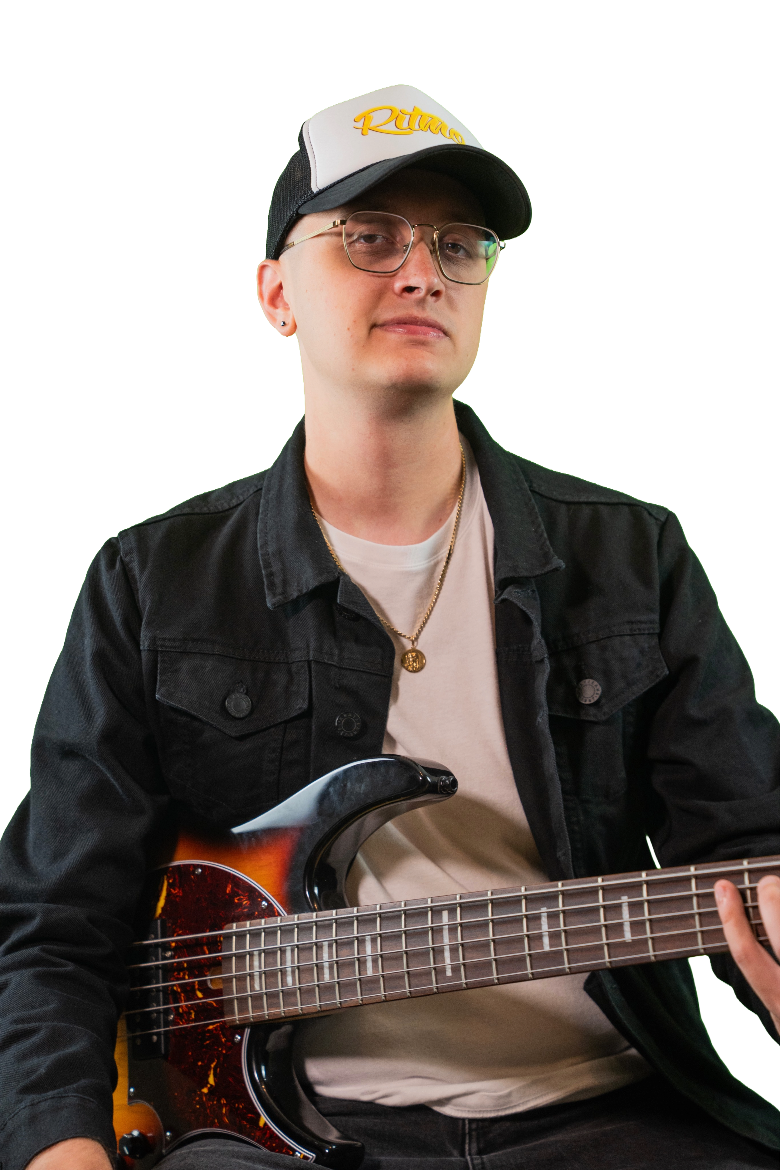 Musician wearing a black cap and glasses while playing a sunburst electric bass guitar