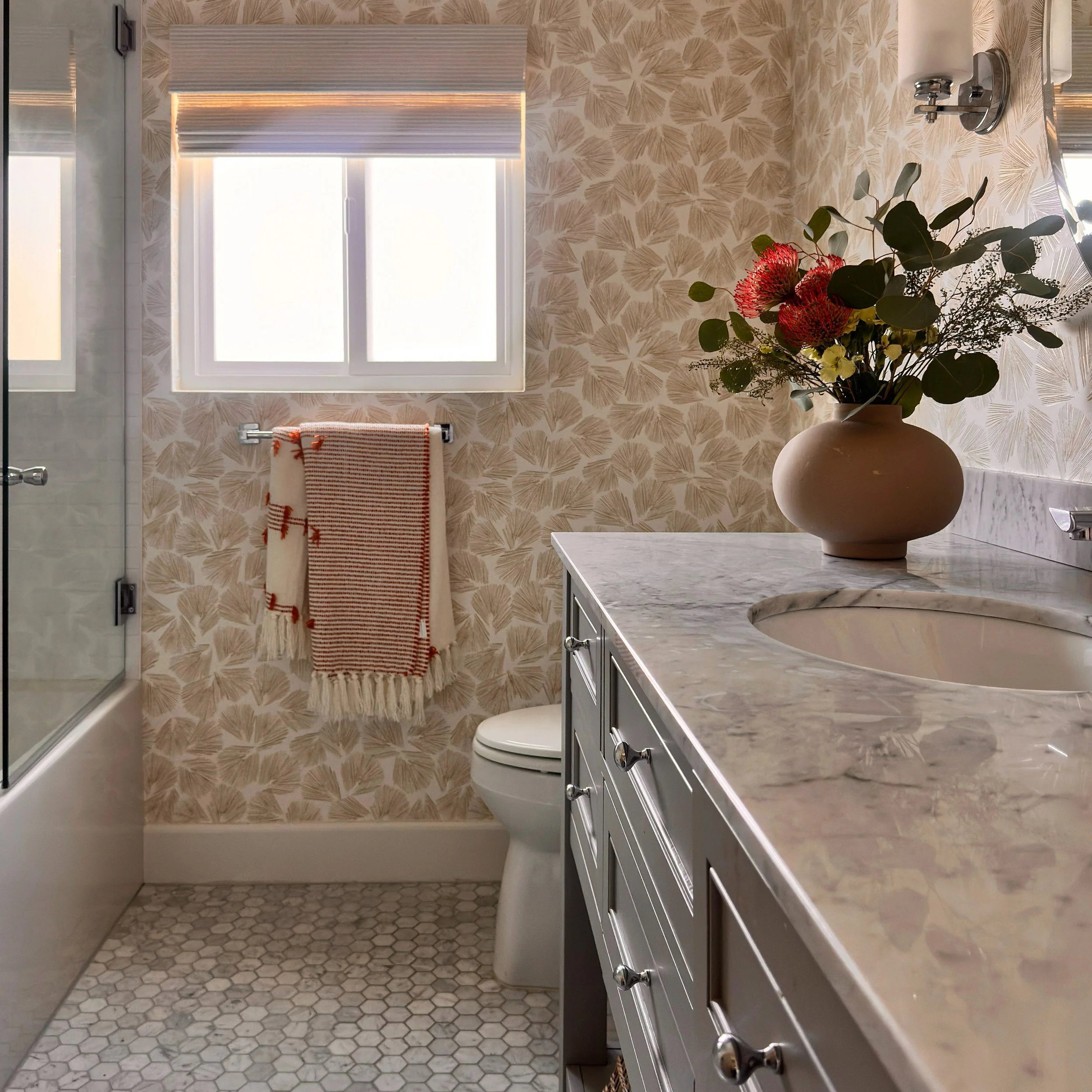 A bathroom can feel completely transformed with a few thoughtful updates.

Wallpaper brings personality and movement to the room, while an updated vanity gives the space a fresh, polished foundation. The right floral arrangement adds softness, color 