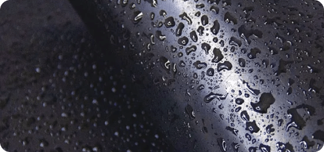 close-up of water droplets on a dark surface