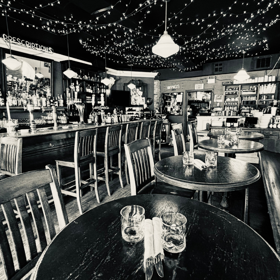 Interior shot of Desotos eatery photos, which is an Italian restaurant on st Clair and Dufferin St in Toronto. This is an elegant black and white photo of  the front bar where they offer craft cocktails, local Toronto brewed craft beers and wine