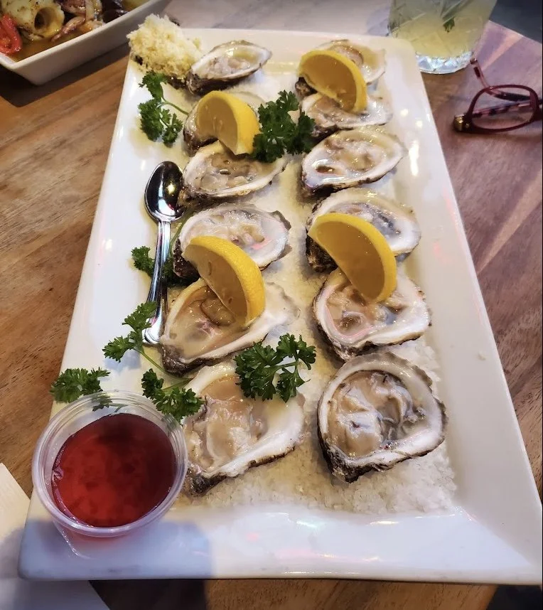 Desotos fresh PEI Malpeque Oysters delicately platted and served with wine sauce and horseradish