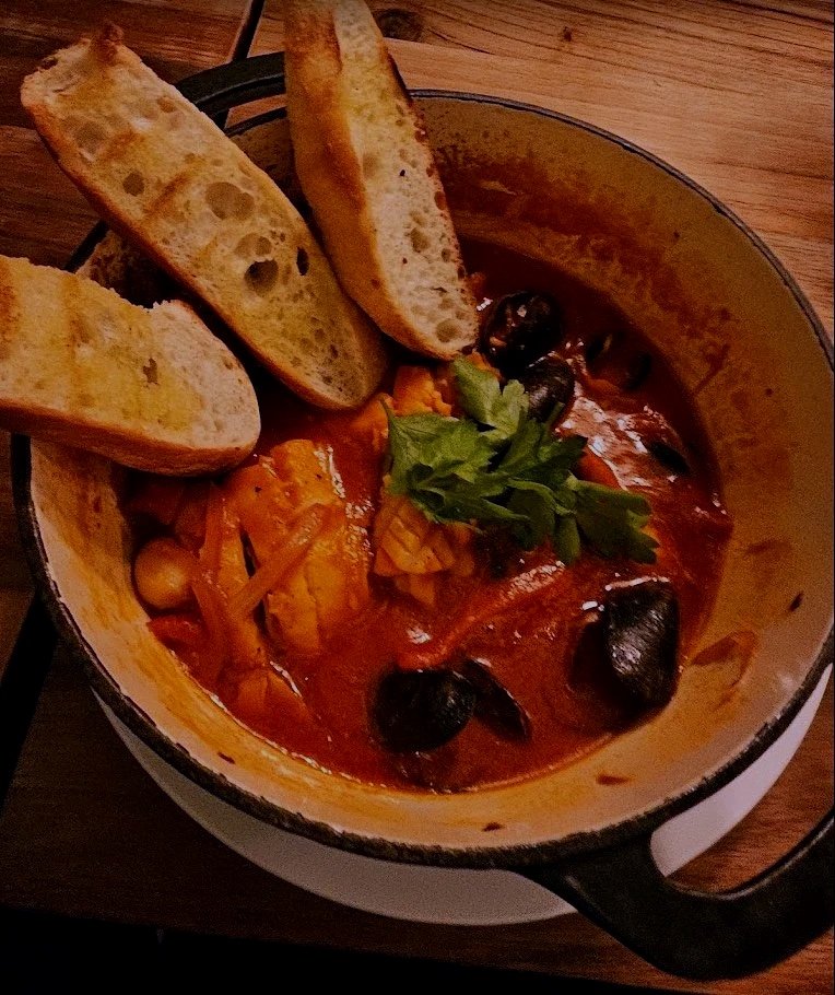 A hearty seafood stew with mussels, cod, shrimp, and calamari in a roasted garlic tomato broth at Desotos Eatery.