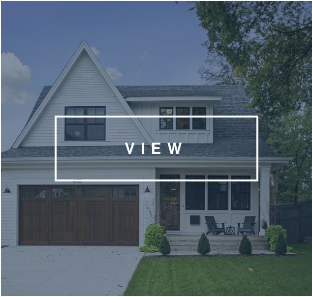 White home facade with black windows and wood 2-car garage
