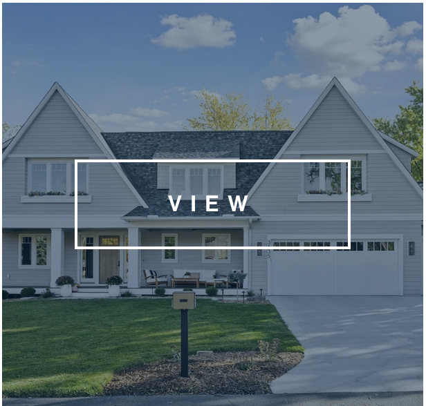 grey and white home facade with front porch and two car garage