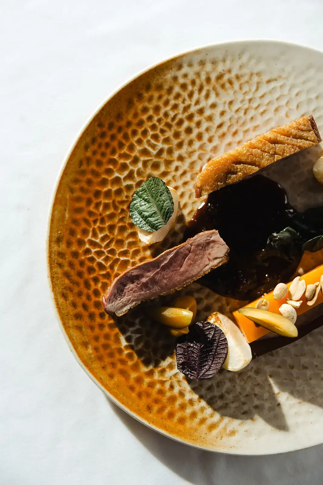 Close-up of a plated dish with rich textures and warm tones