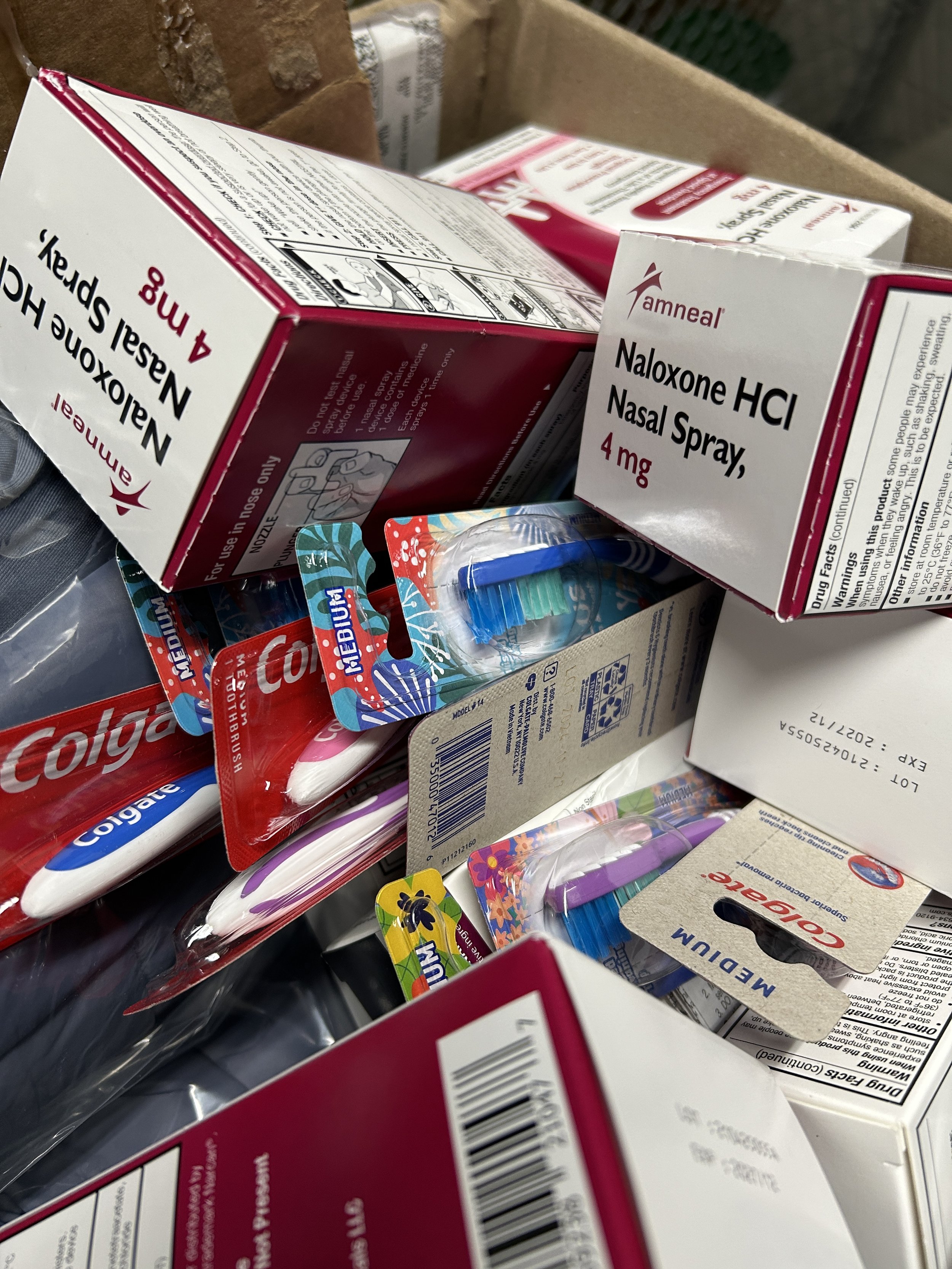 A photo of toothbrushes, hygiene supplies, and narcan to be distributed to the community.