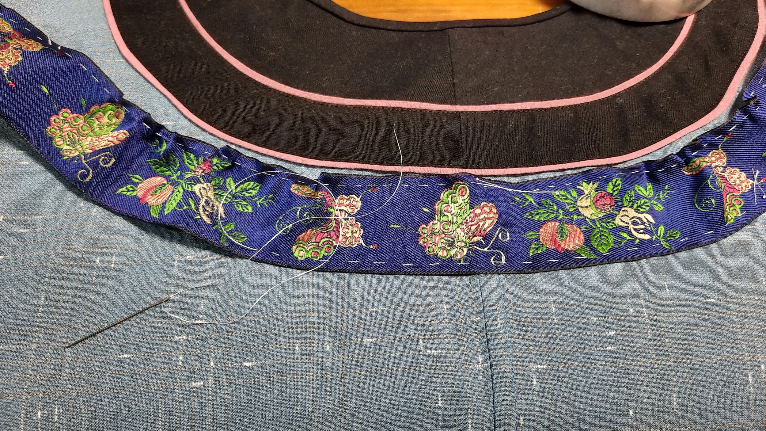 Silk ribbon is gathered at inner edge by hand before stitching to garment