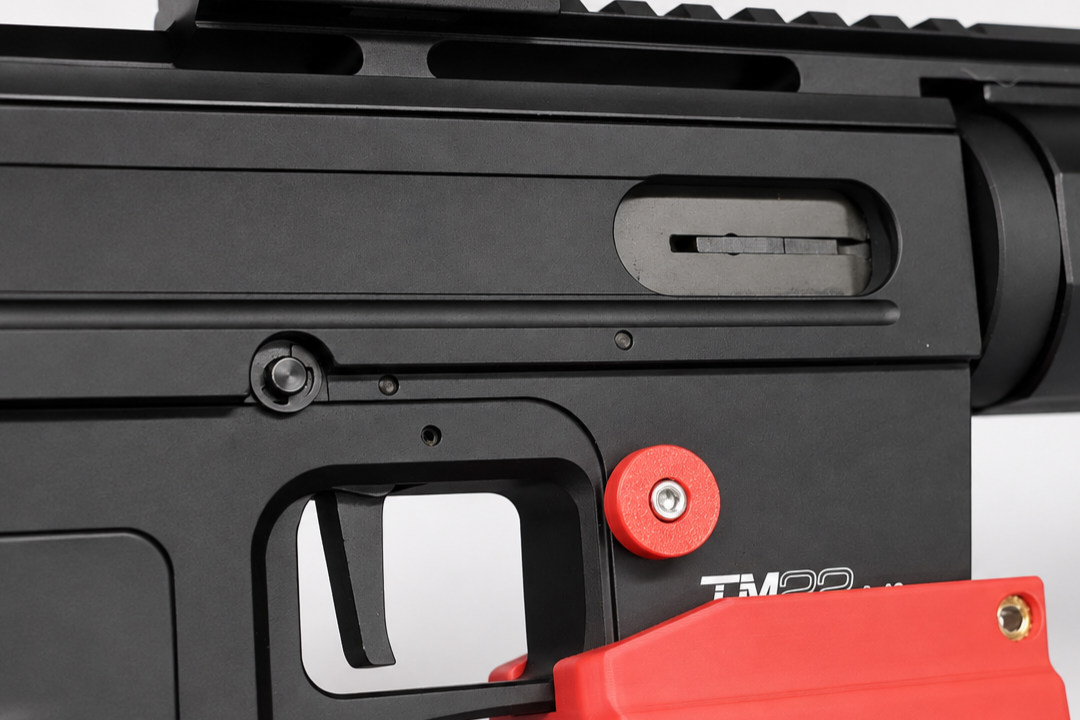 derya_tm22_red_magwell_mag_release_installed_detail_website.png
