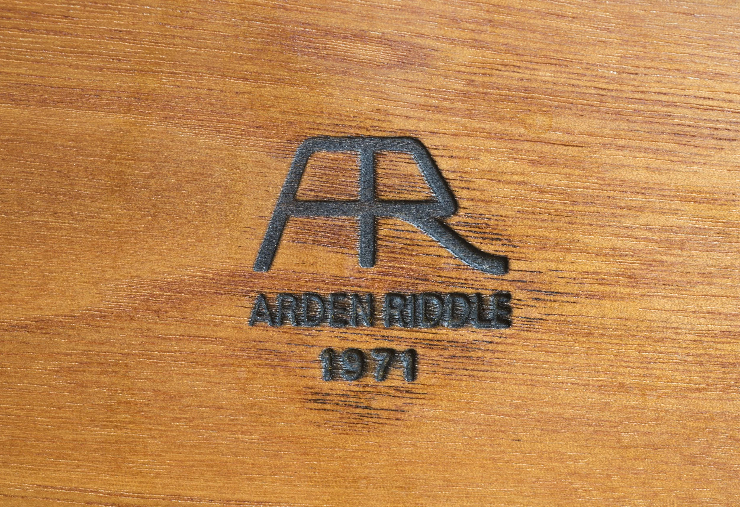 Arden Riddle logo burnished into a wooden table.