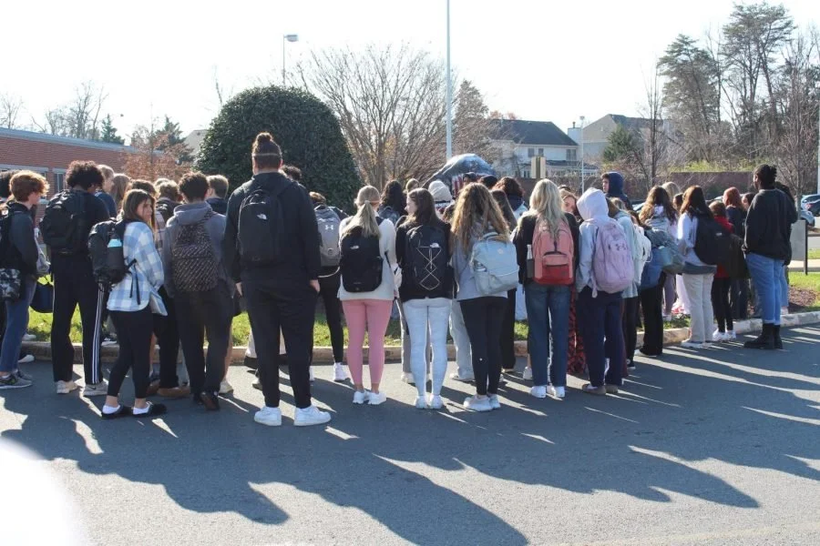  Circling around the rock, students stood silently for 63 seconds. (Caelan Jones) 
