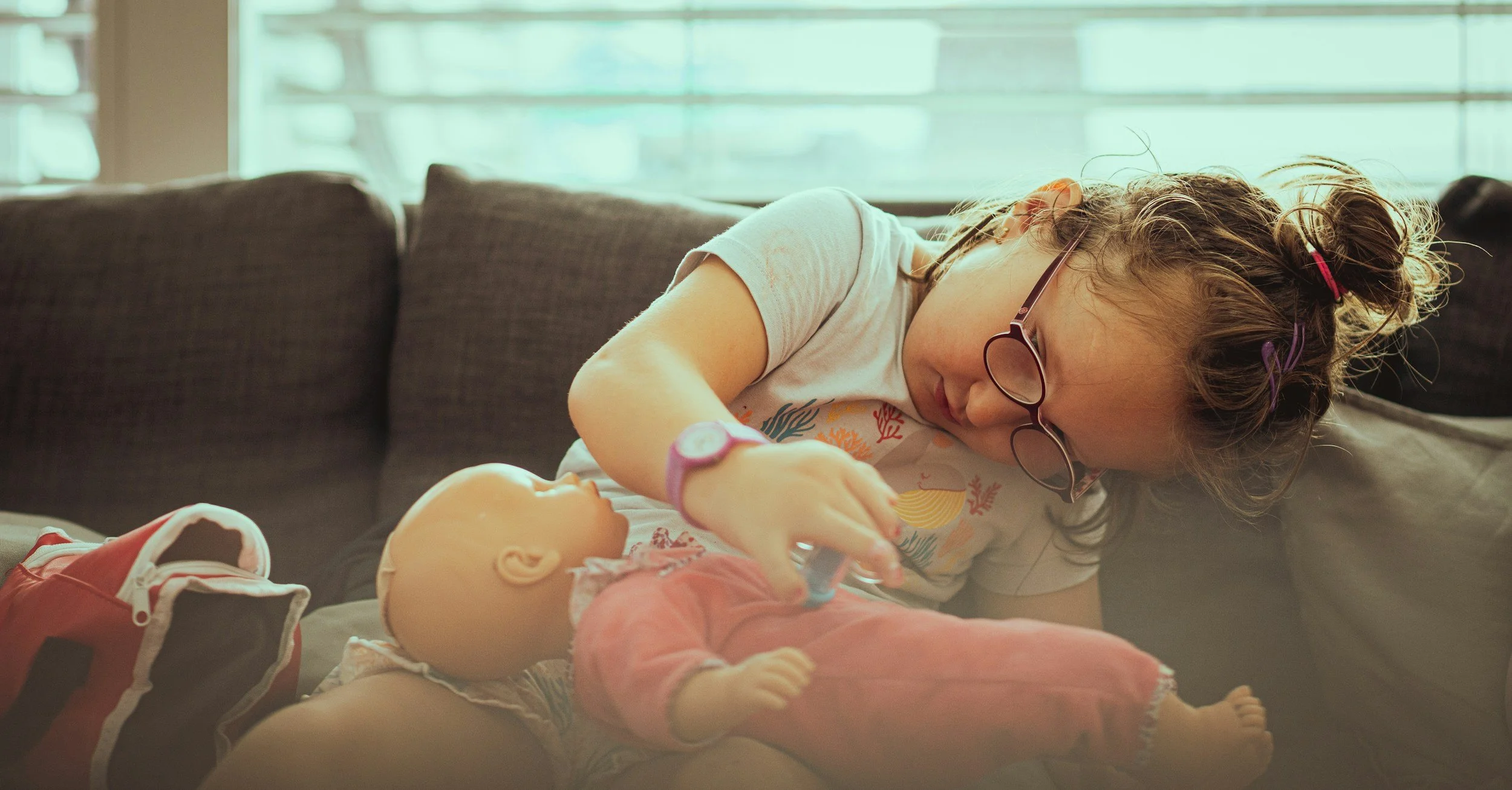 a child plays with a doll