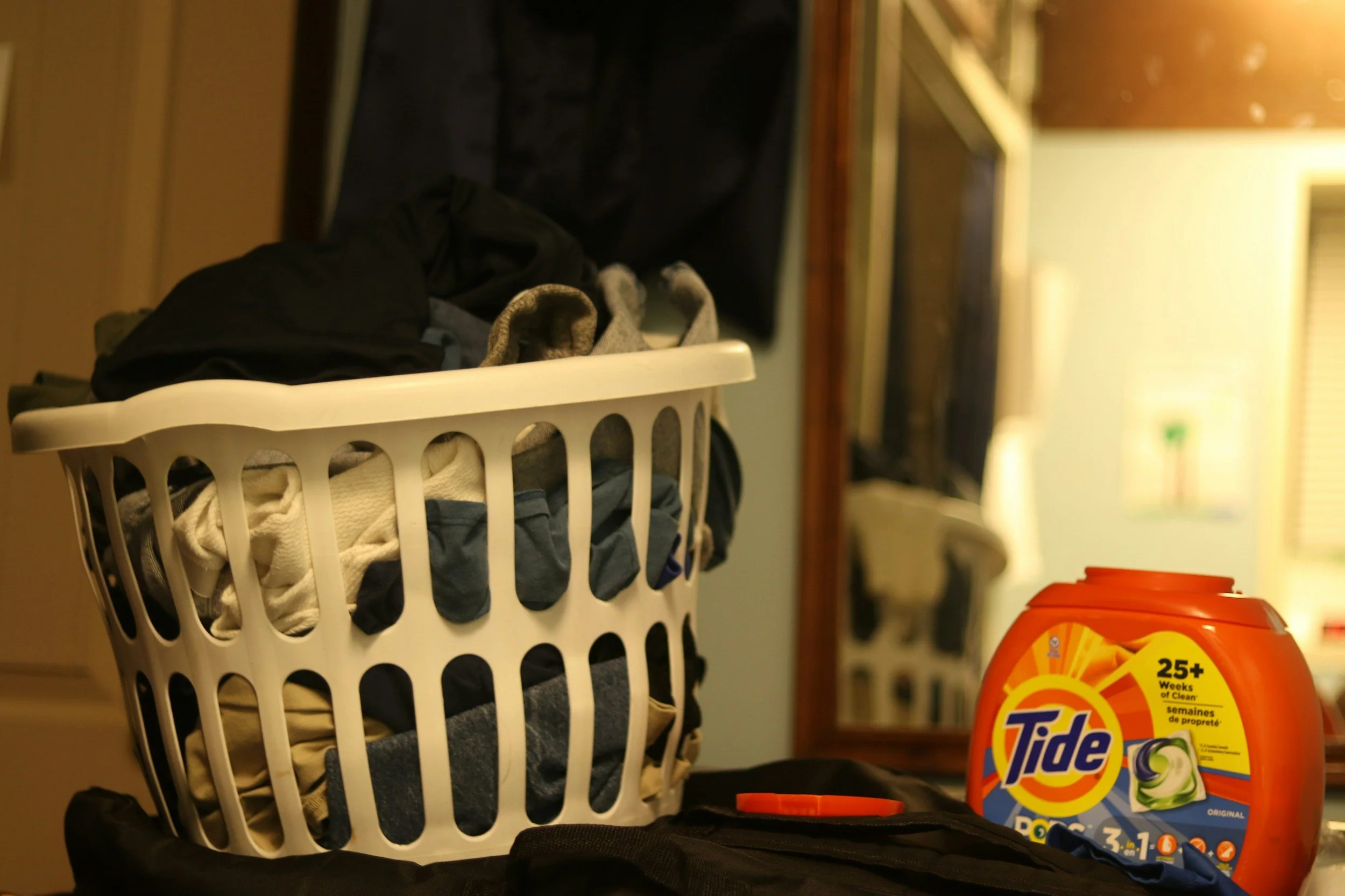 a basket of laundry sitting next to detergent