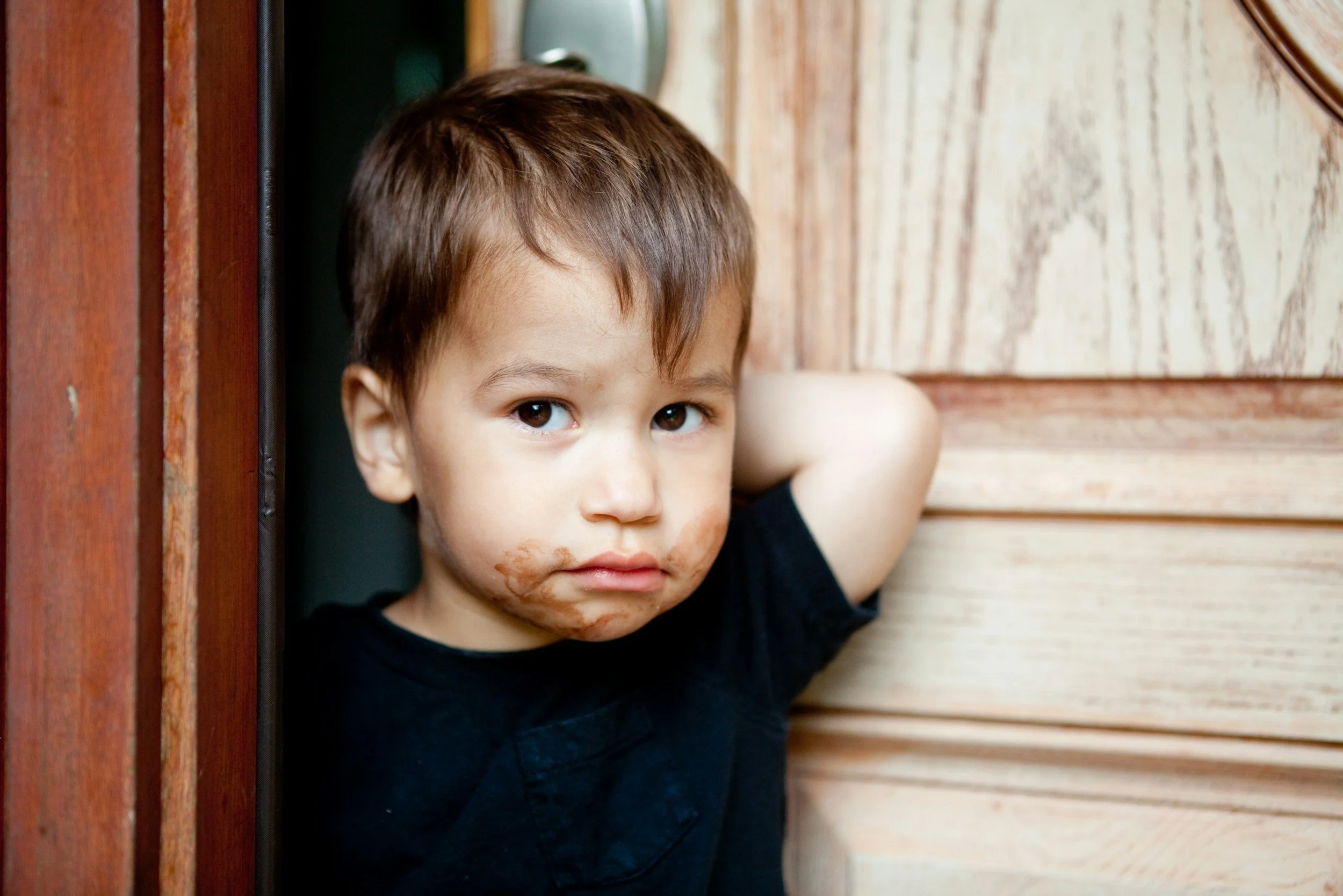 a guilty child with chocolate on their face