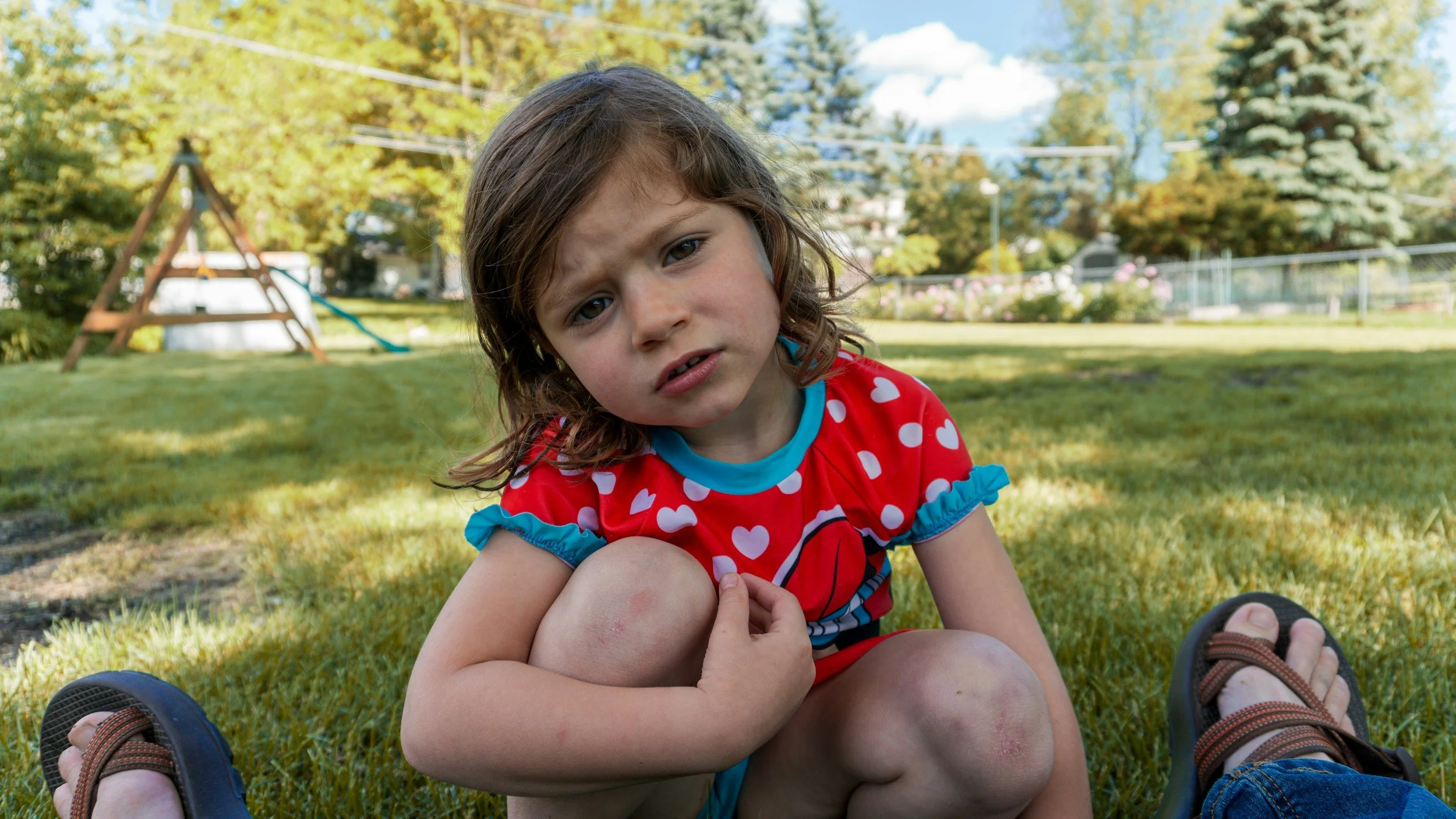 a child pouts to their parent