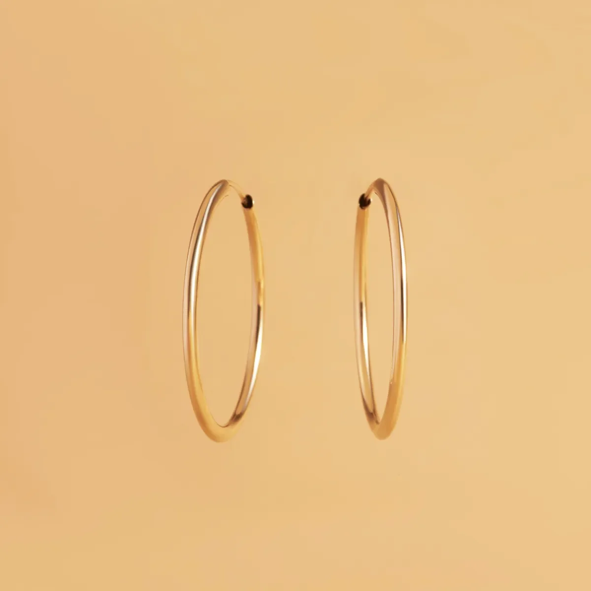 Luxe Sparkles LS-E050: polished 14kt yellow gold flexible tube hoop earrings