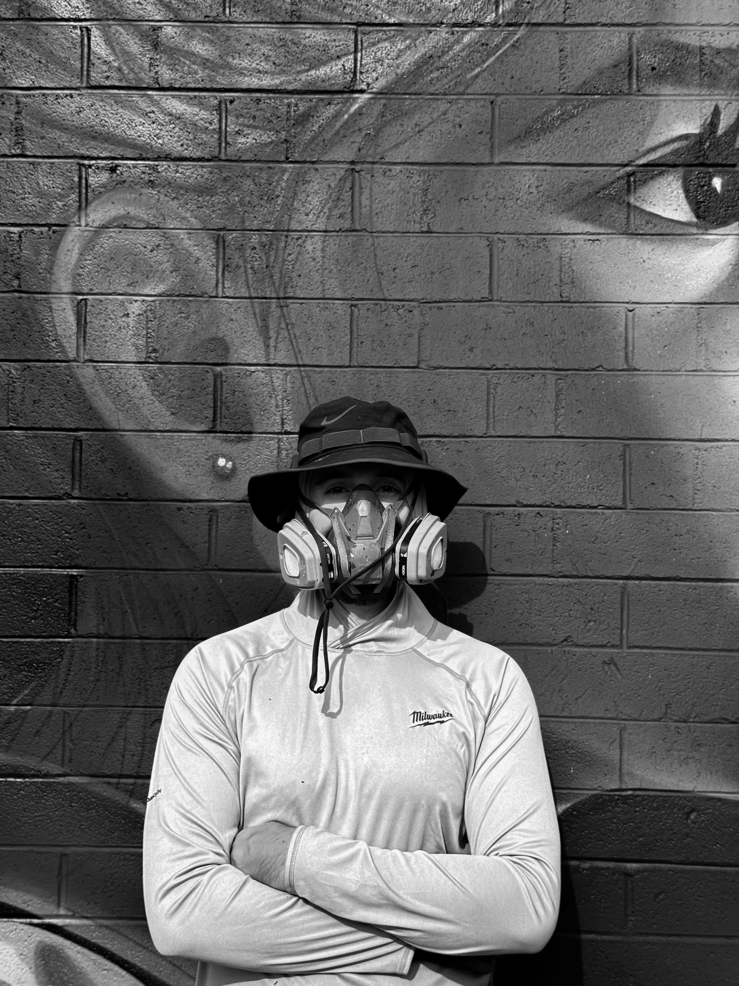 a mural artist wearing graffiti art clothes