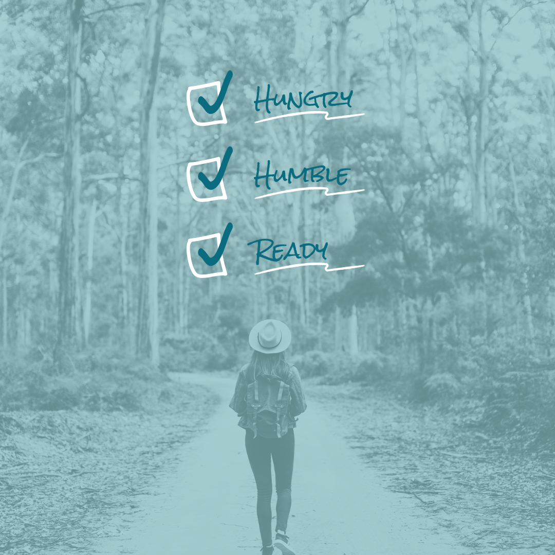 A person walking on a forest path, wearing a hat and backpack, with a checklist overlay showing three items: Hungry, Humble, Ready, all checked off.