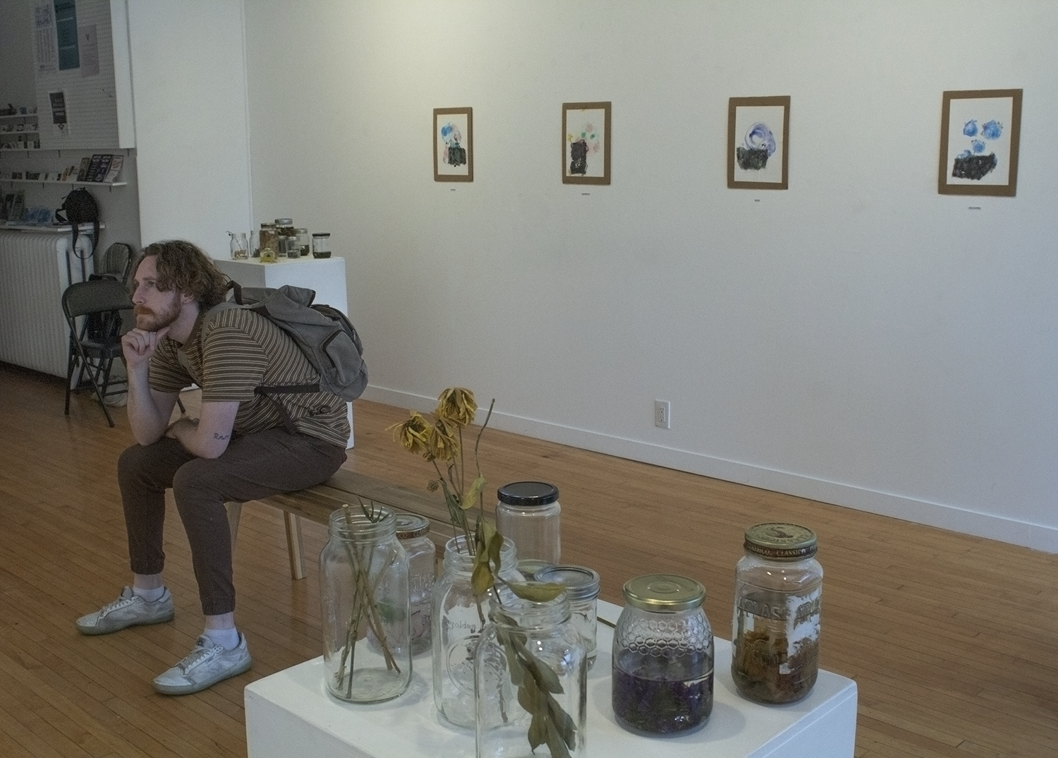 Person sitting and observing exhibition