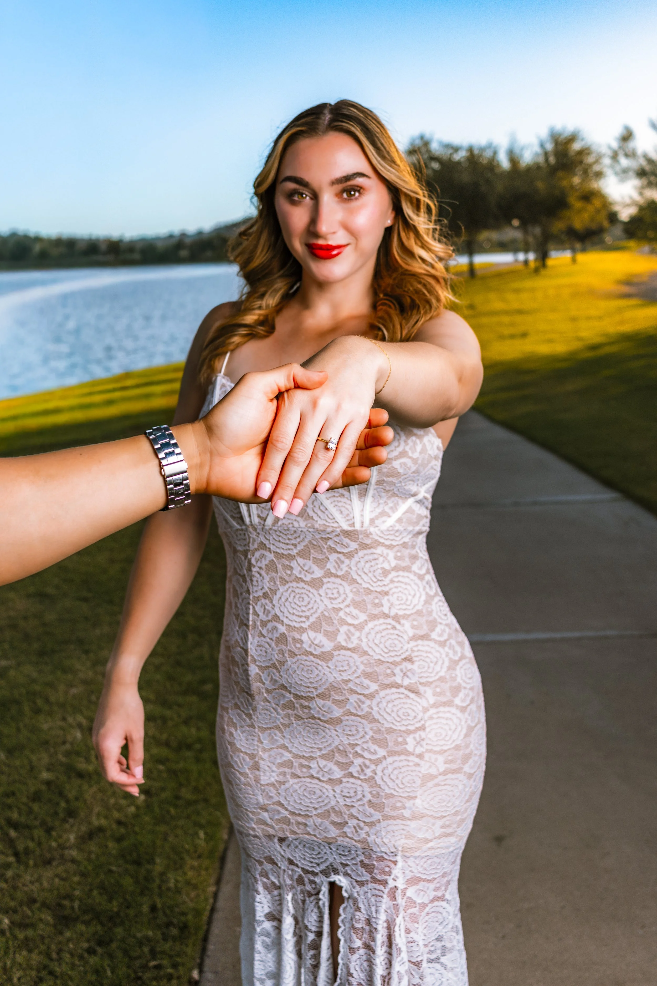 Scottsdale AZ engagement session with couple holding hands on path near water, photographed by BNelly Photography Phoenix
