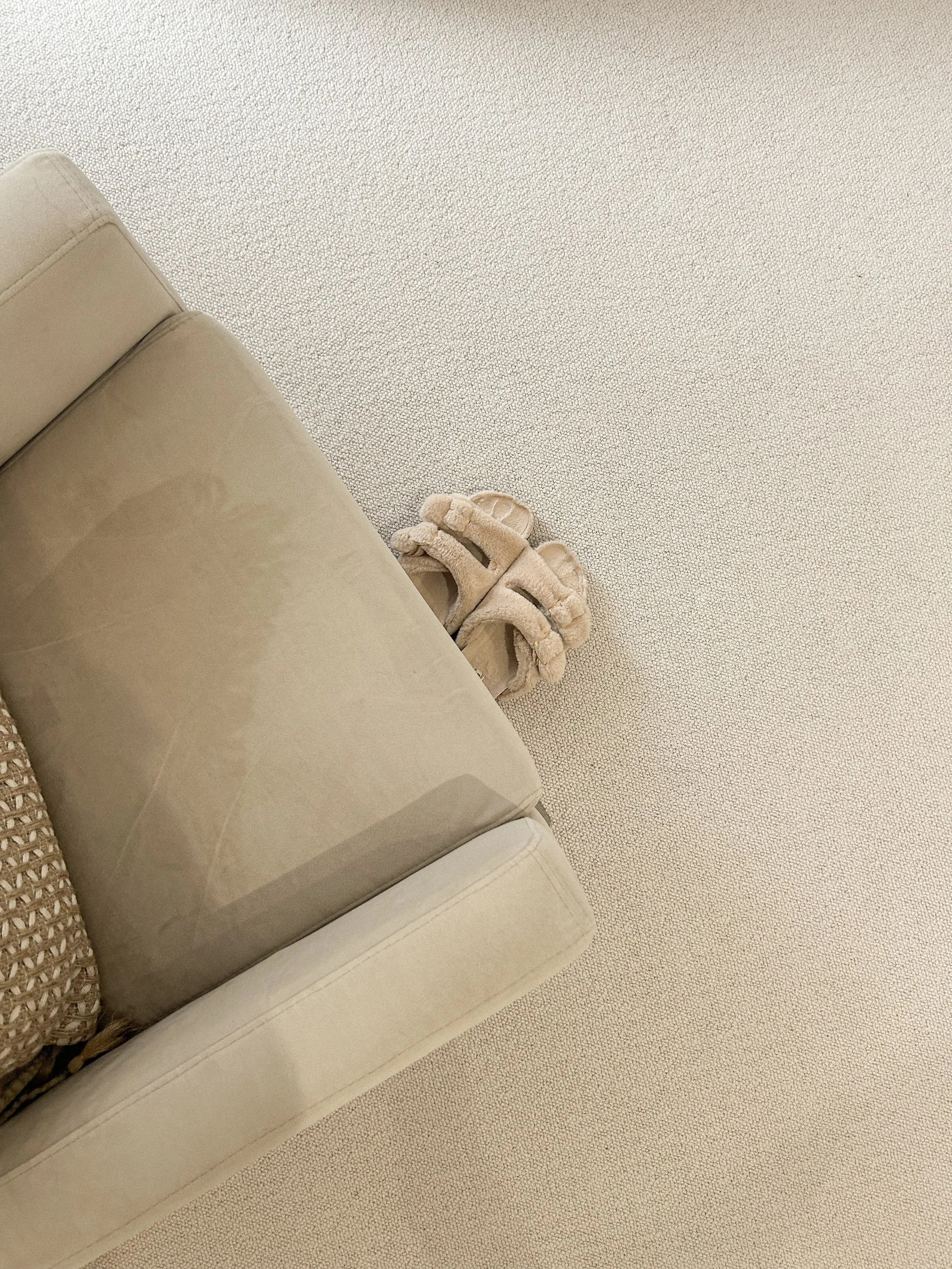 A beige sofa with fluffy slippers on a light-colored carpet.“Residential interior design project in Scotland by [Studio Name], working across Glasgow, Edinburgh, Dundee and the Highlands.”

“Contemporary Scottish interior design by [Studio Name], ser