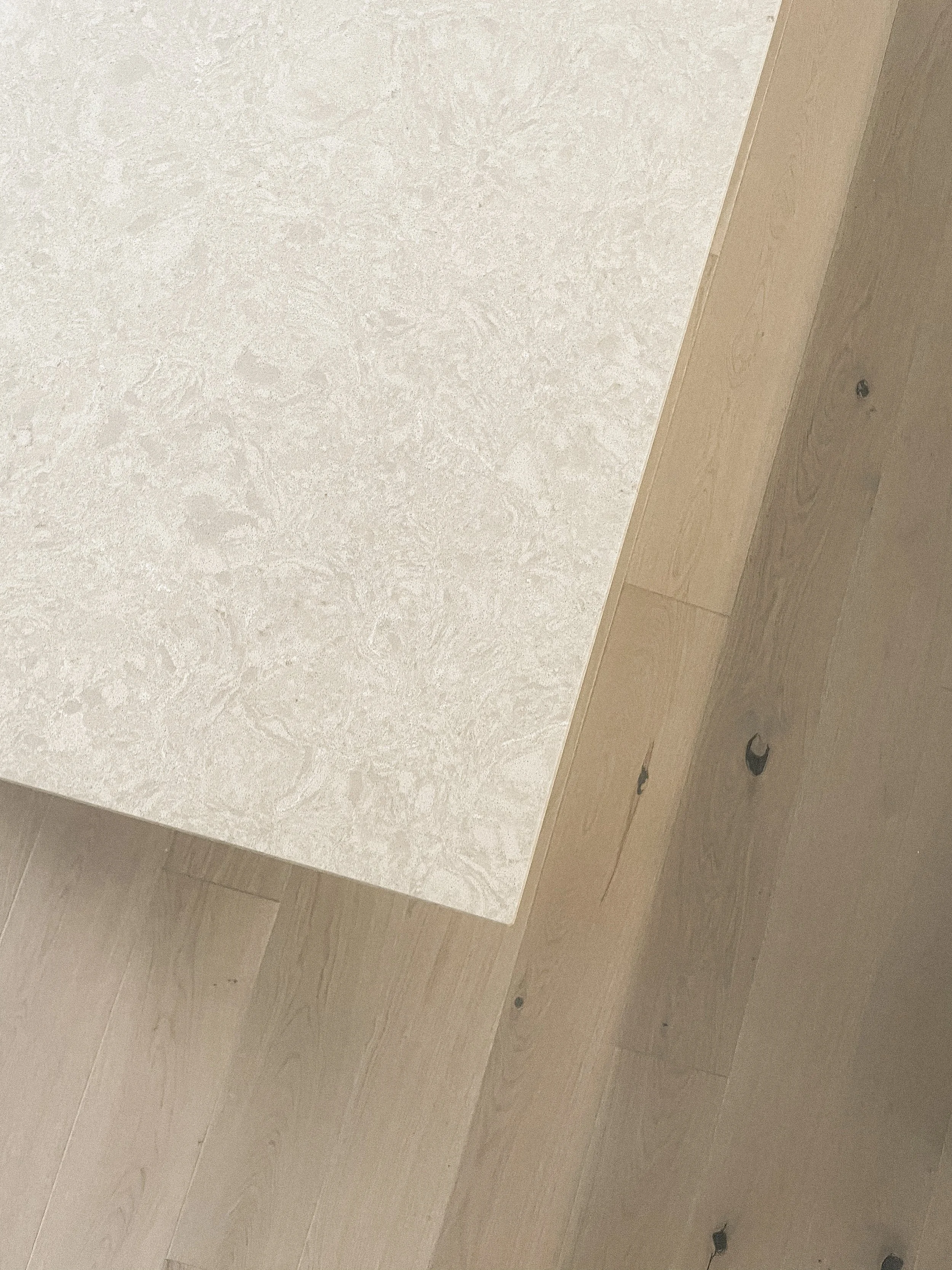 A close-up view of a wooden table or countertop with a light-colored surface, standing on a wooden floor with visible screws or nails.“Residential interior design project in Scotland by [Studio Name], working across Glasgow, Edinburgh, Dundee and the