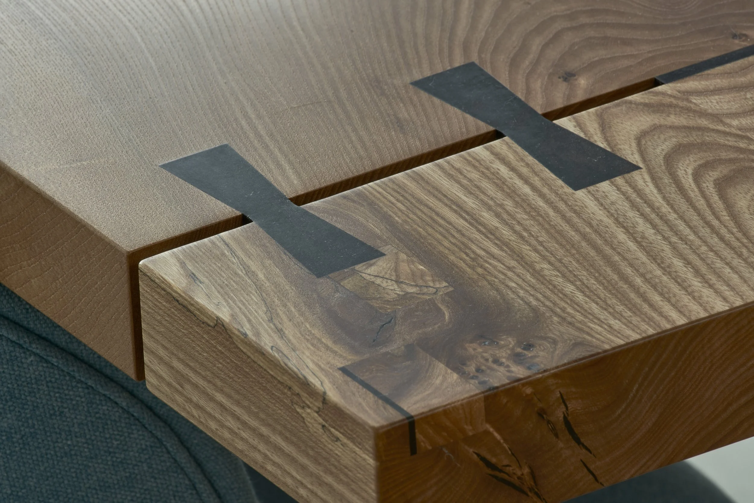 Close-up of a wooden table with black tape strips attached to its surface.Residential interior design project in Scotland - Interior Designer Scotland - Interiors 
