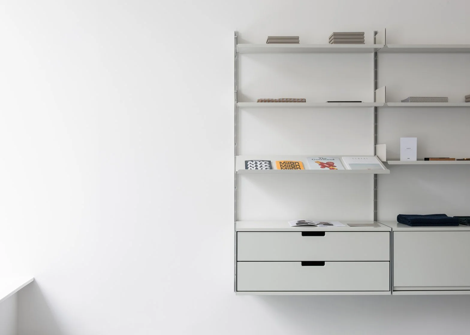 White wall with modern white shelving unit holding books and magazines.Residential interior design project in Scotland - Interior Designer Scotland - Interiors 