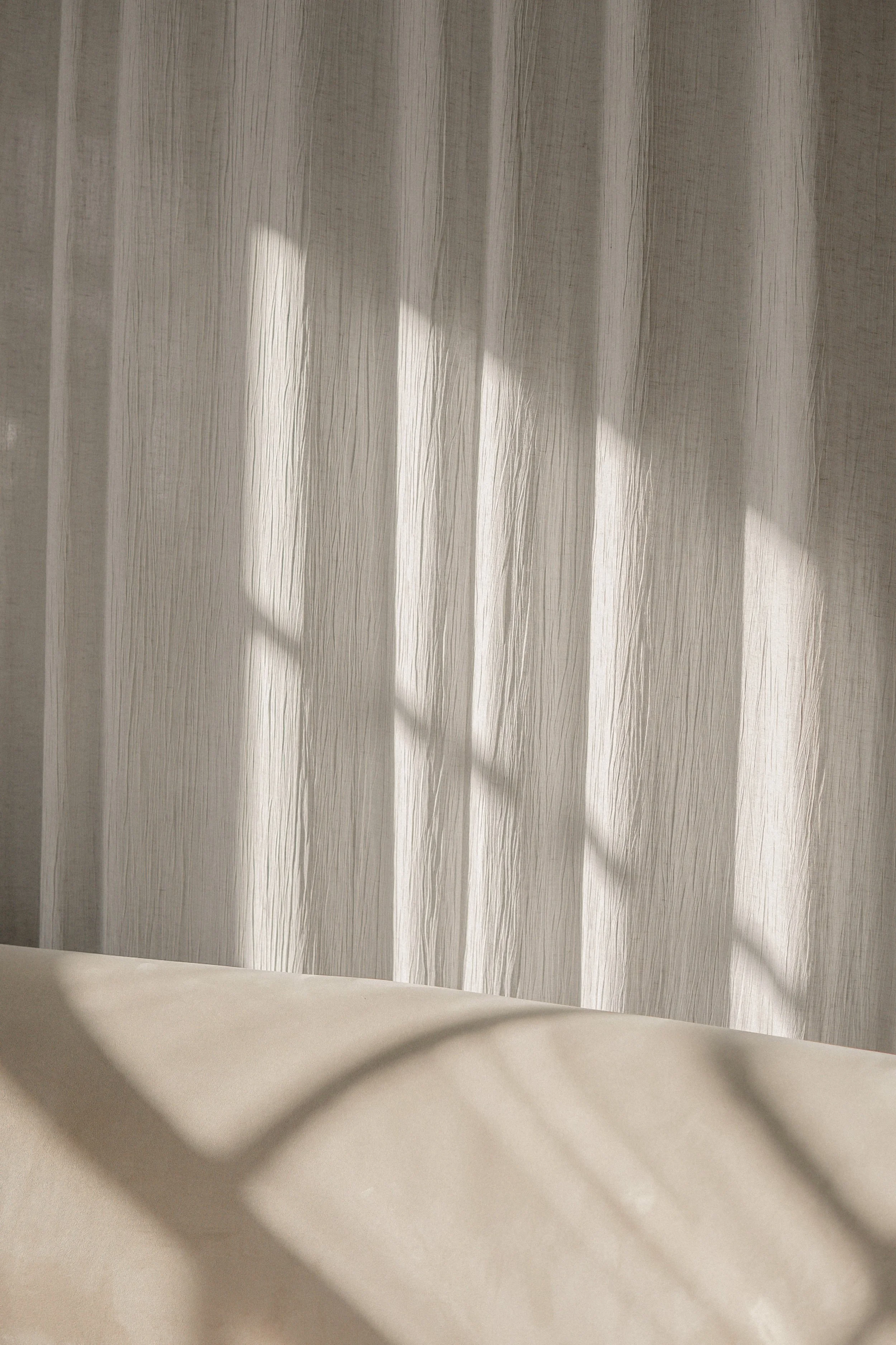 Sunlight casting shadows on a sheer curtain with a faint textured pattern, creating a soft and calming ambiance.“Residential interior design project in Scotland by [Studio Name], working across Glasgow, Edinburgh, Dundee and the Highlands.”

“Contemp