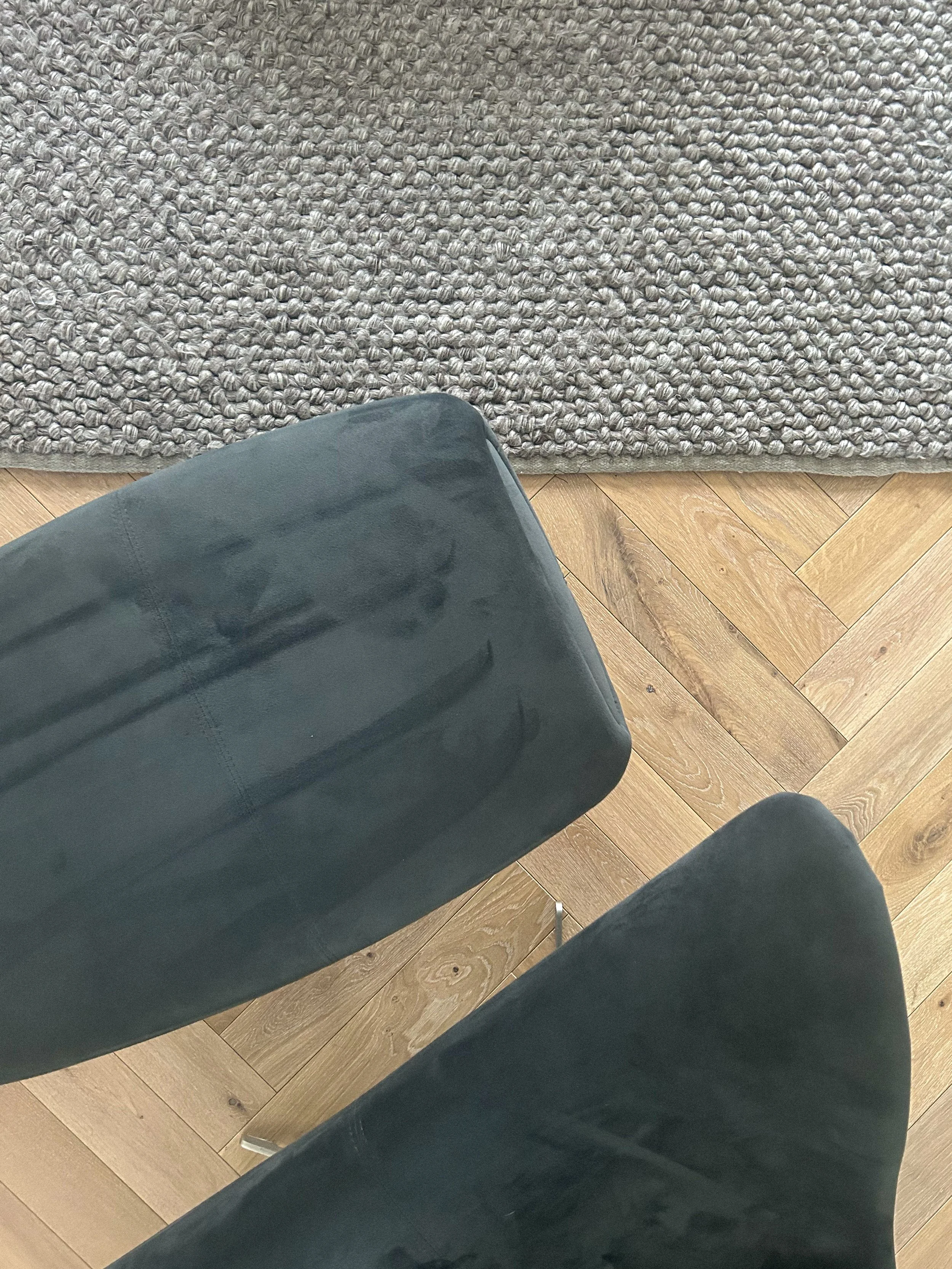 Top-down view of two dark-colored chairs, a beige textured rug, and a hardwood floor in a room.Residential interior design project in Scotland - Interior Designer Scotland - Interiors 
