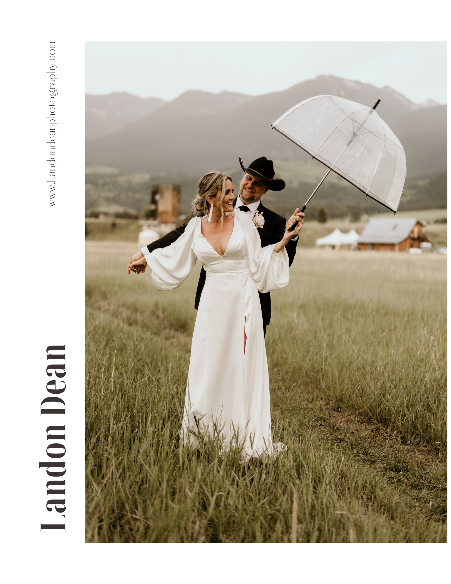 Couple in wedding attire standing in a grassy field holding an umbrella, with mountains in the background. The bride wears a white gown and the groom a suit with a cowboy hat. "Landon Dean Photography" is on the side.