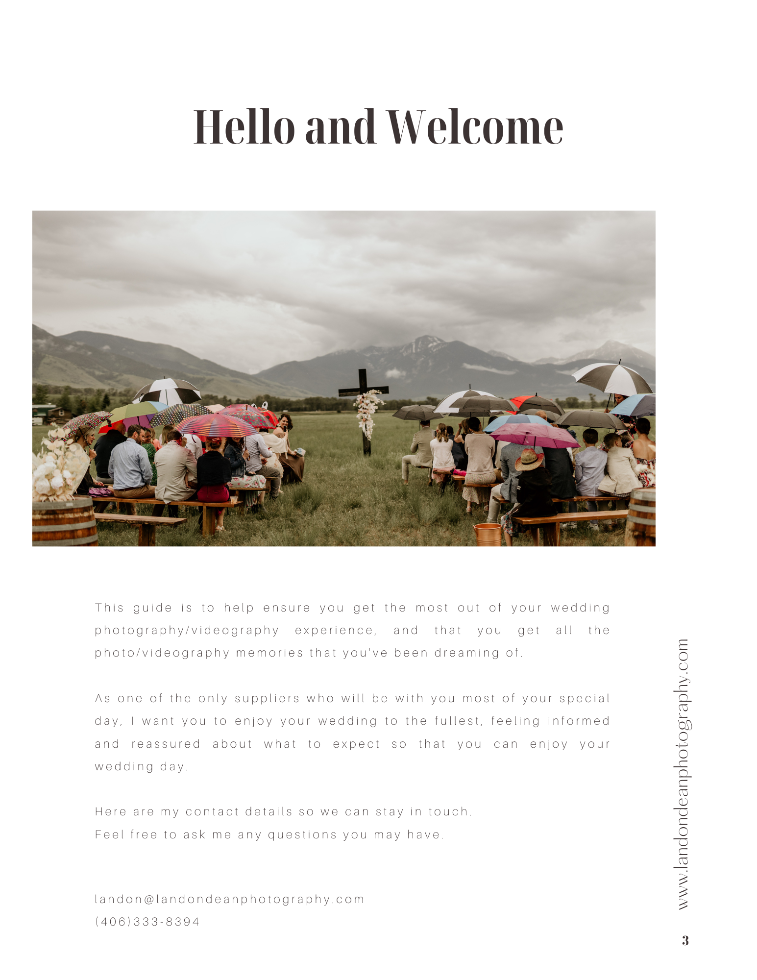 Outdoor wedding ceremony with guests under umbrellas facing a platform with cross, mountainous landscape in the background.