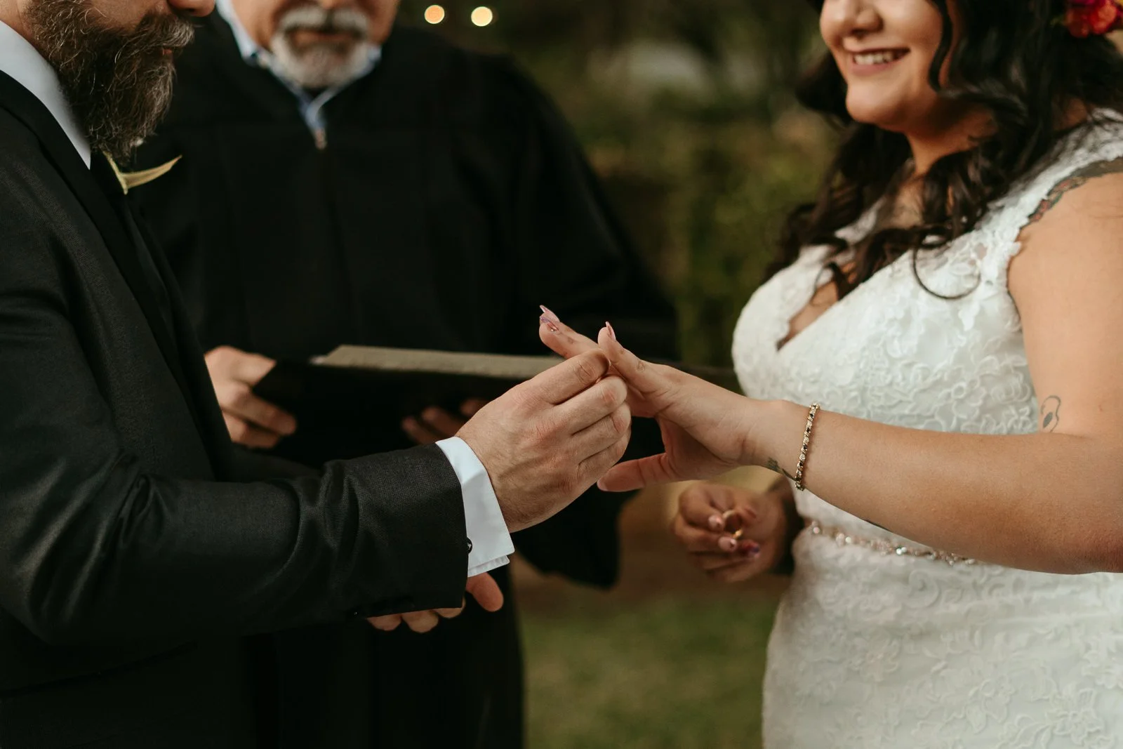 couple exchanging rings during their backyard ceremony