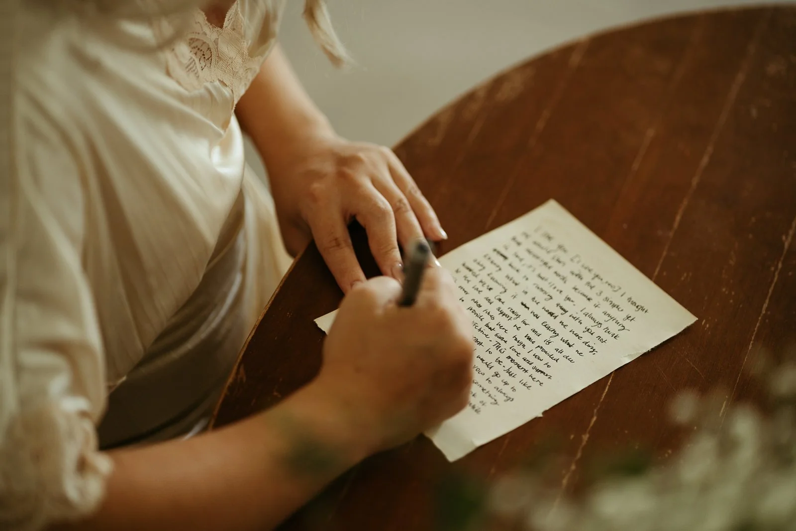 a bride writing down her vows on the morning of her wedding day