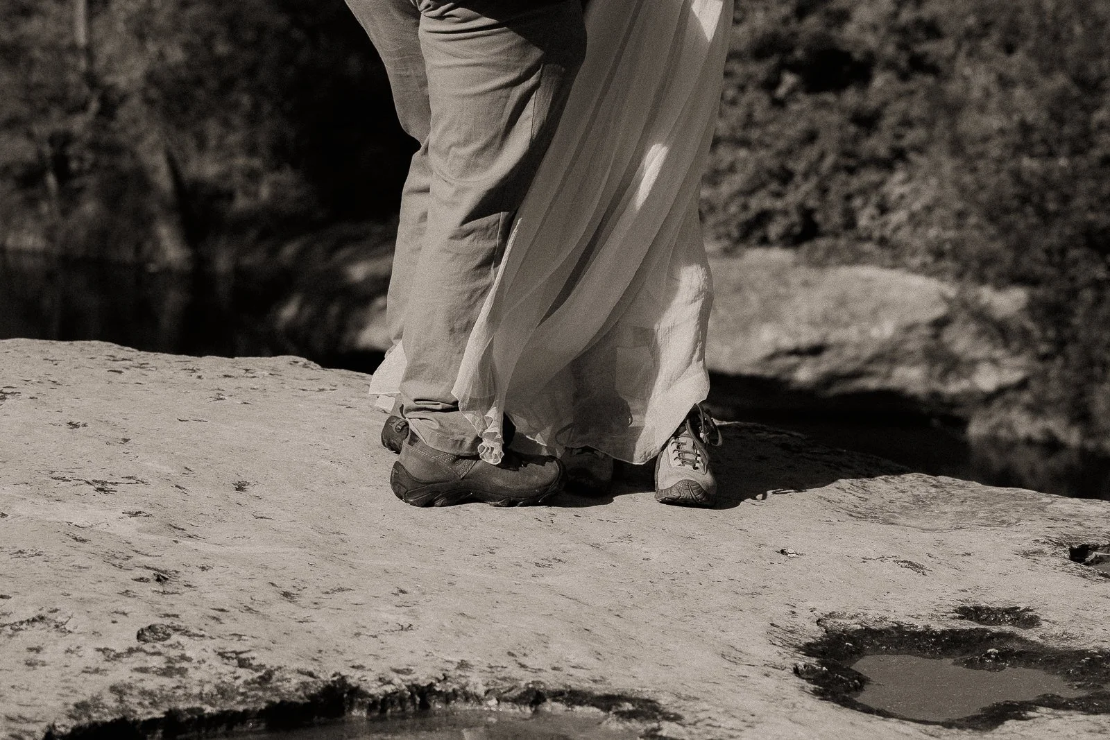 Dan and Carolyn's boots as they stand together on a limestone cliff overlooking Onion Creek