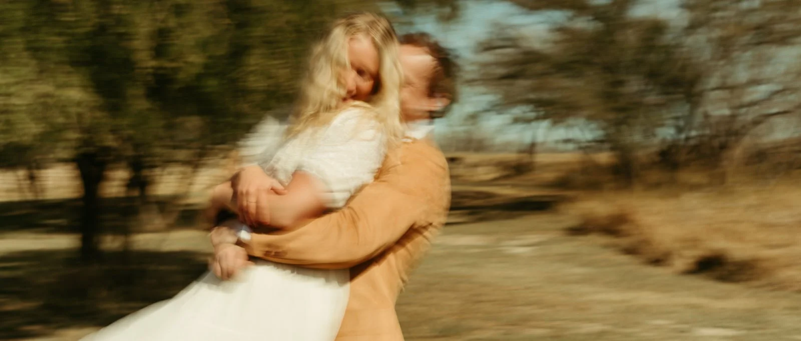 Sawyer picking Nikki up and spinning her around while they danced together.