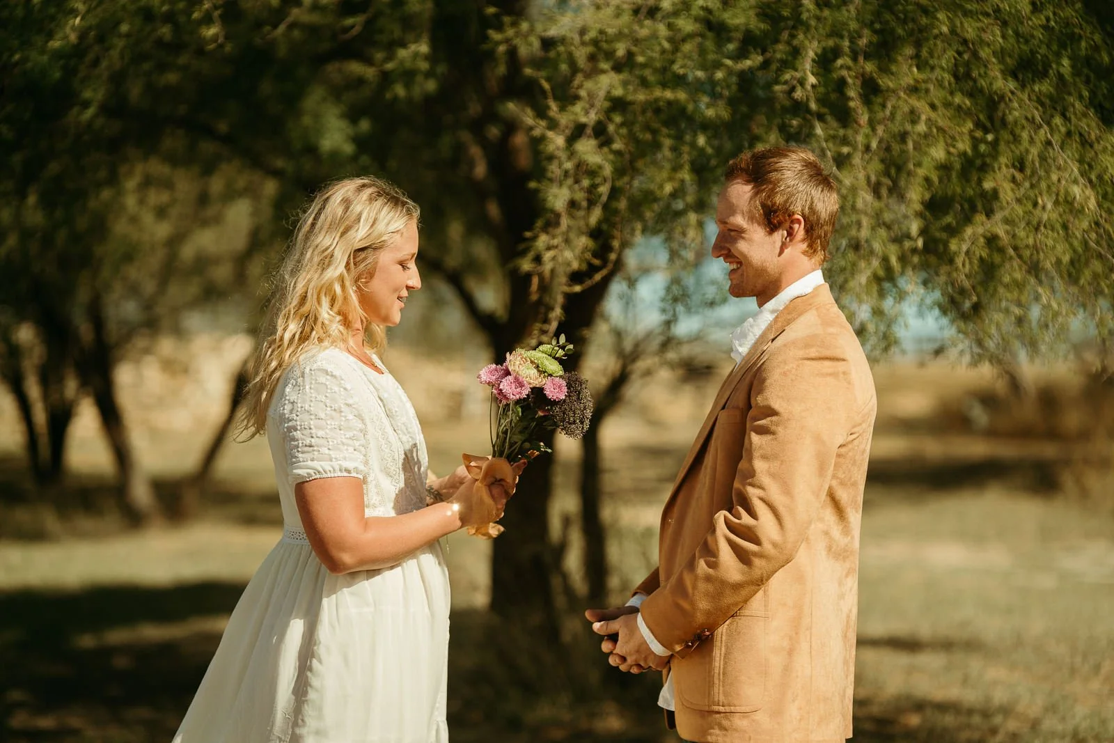 Sawyer smiling as he listens to Nikki read out her vows.