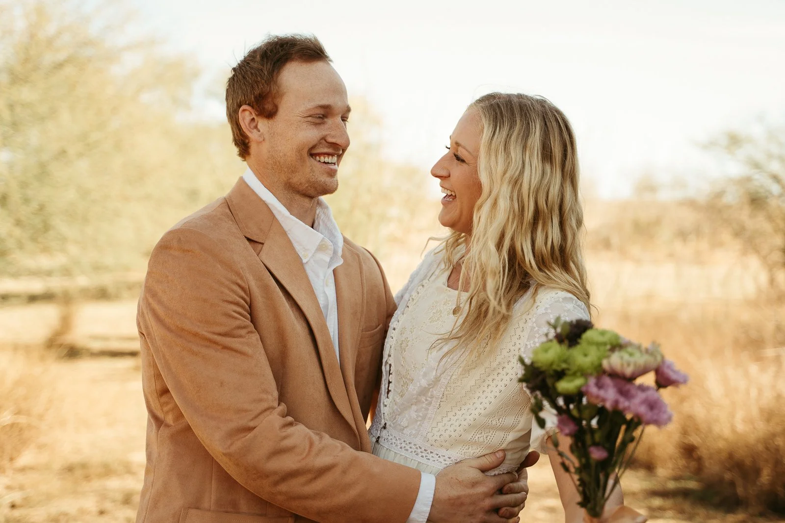Sawyer holding Nikki as they laugh together.