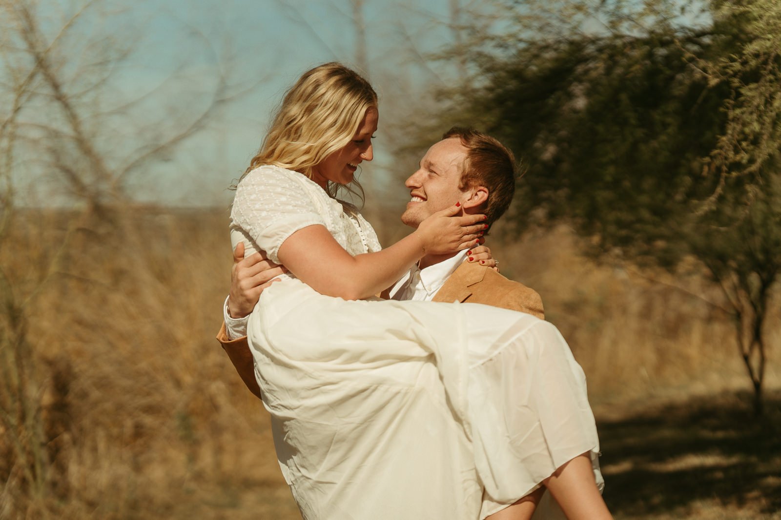 Nikki smiling as she held Sawyer’s face while he carried her.