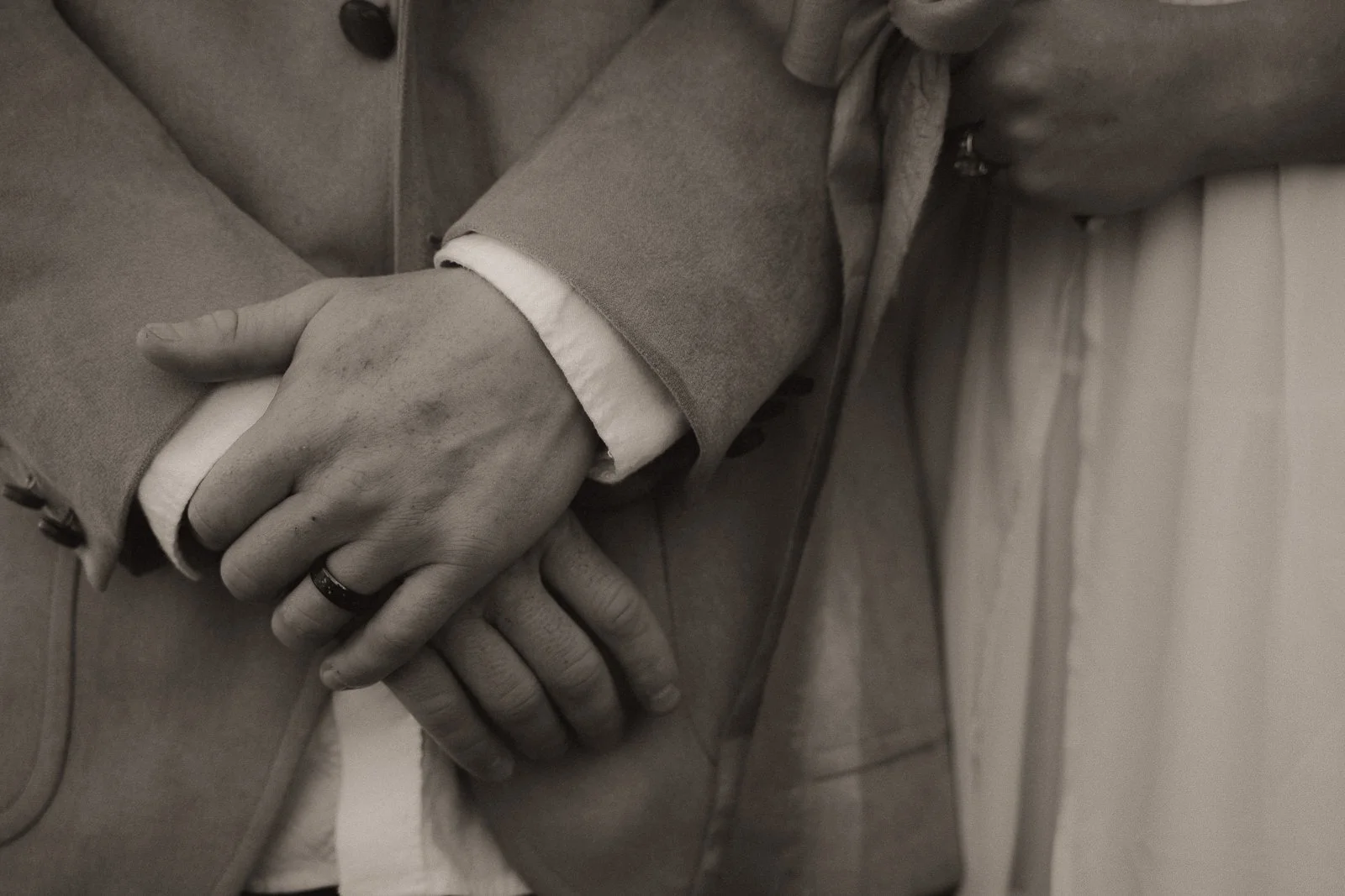 Sawyer’s wedding band on his hand while Nikki cuddles him before their ceremony.