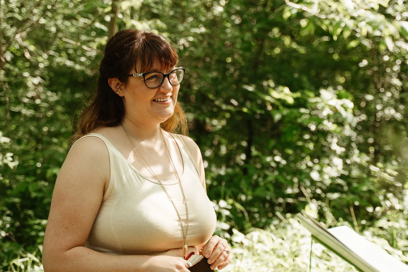Carolyn smiling as she listens to Dan read his vows