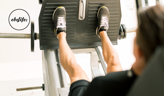 A person performing a leg press exercise in the gym