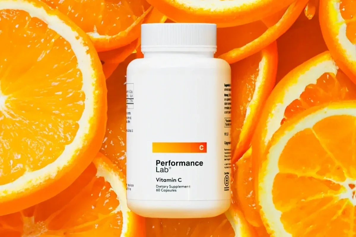 Performance Lab Vitamin C supplement surrounded by orange slices
