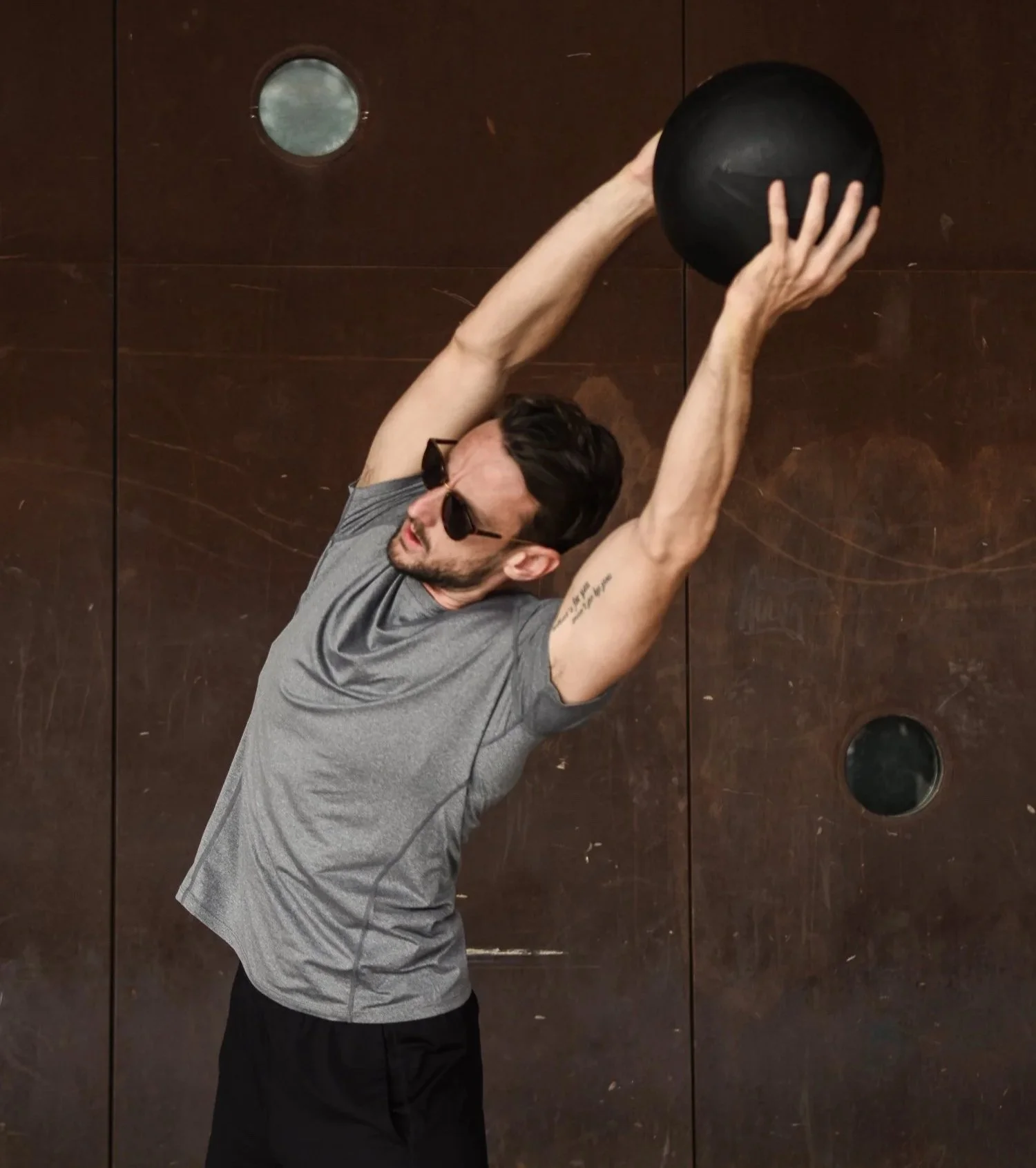 Martin Ebner lifting a medicine ball over his head in Barcelona