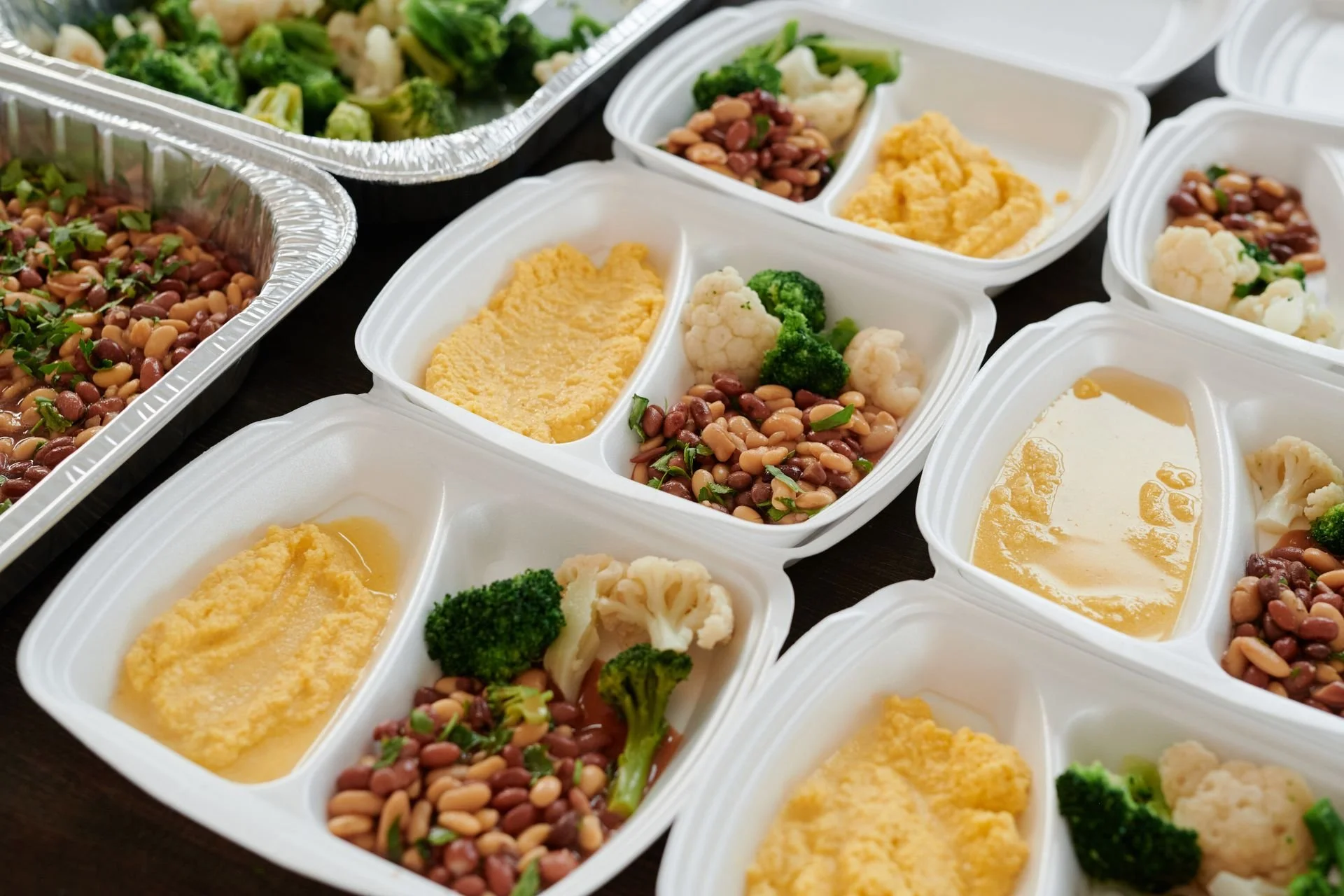 Prepared meals with vegetables and beans arranged for the week