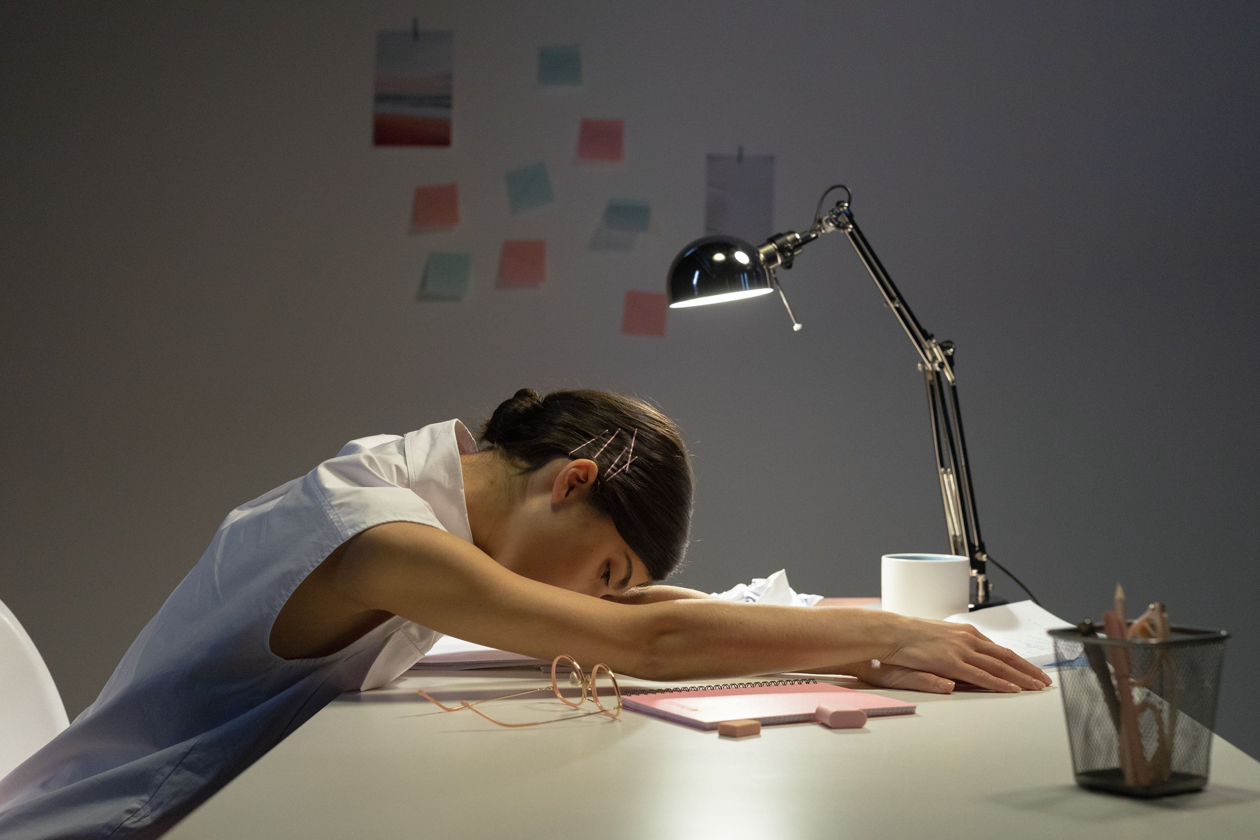 Tired woman resting her head on a desk