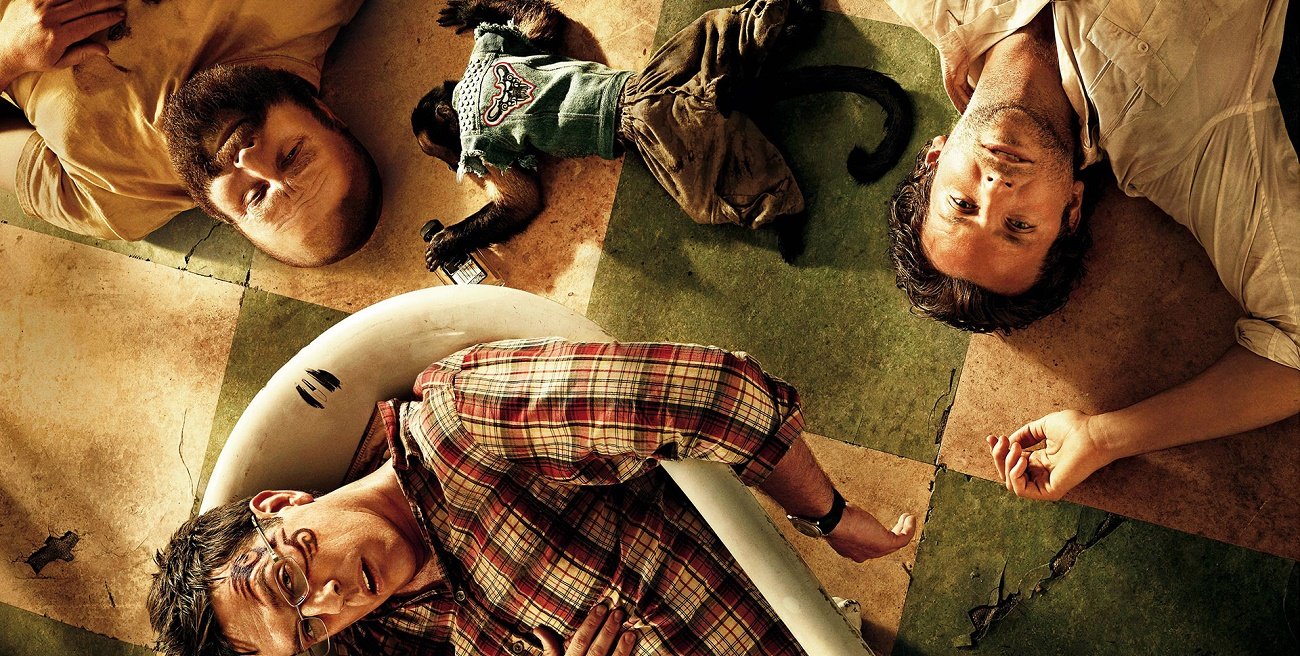 Group of friends lying on the floor after a night out, illustrating an article on hangover recovery