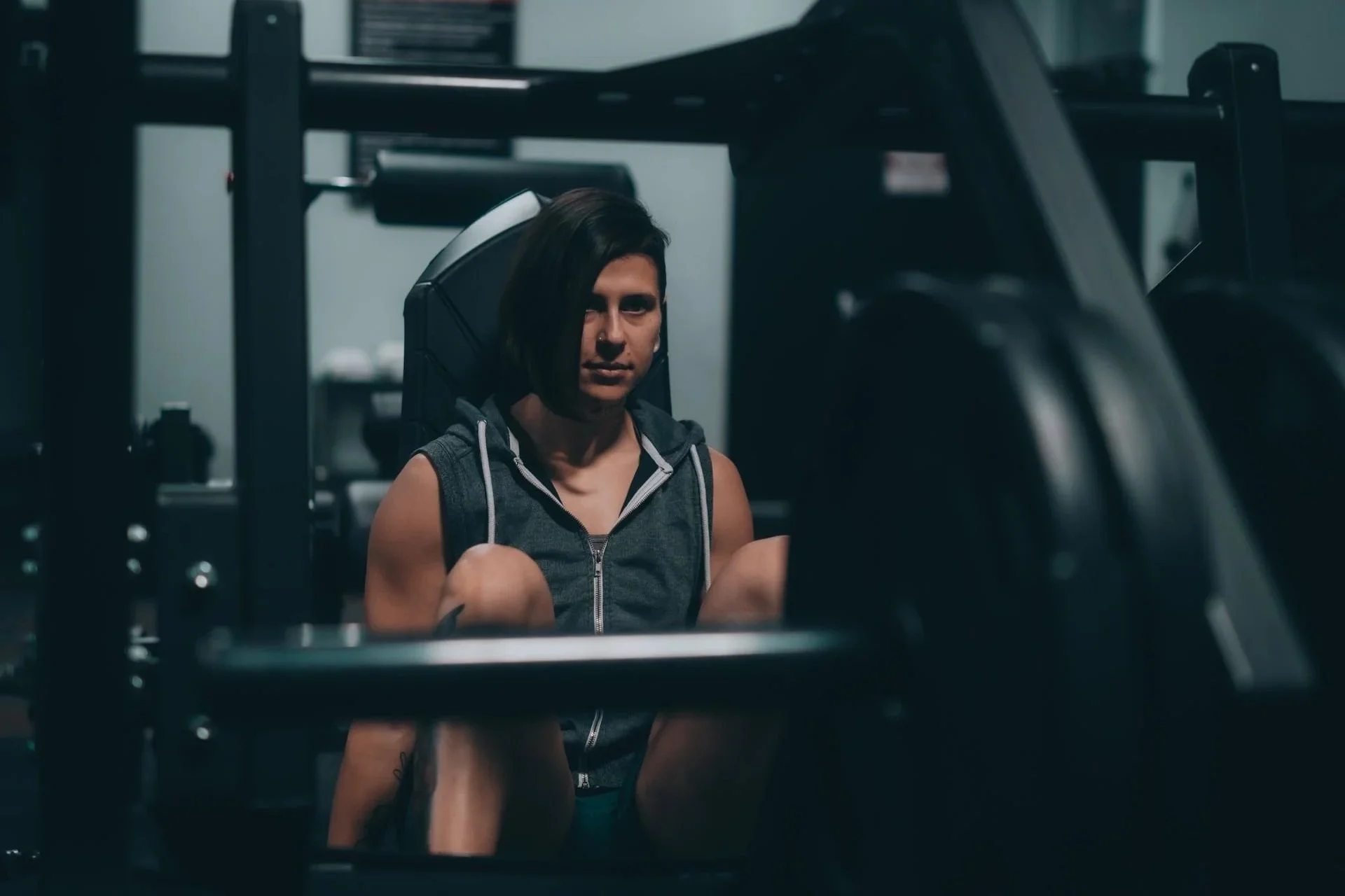 Woman sitting between sets at the gym