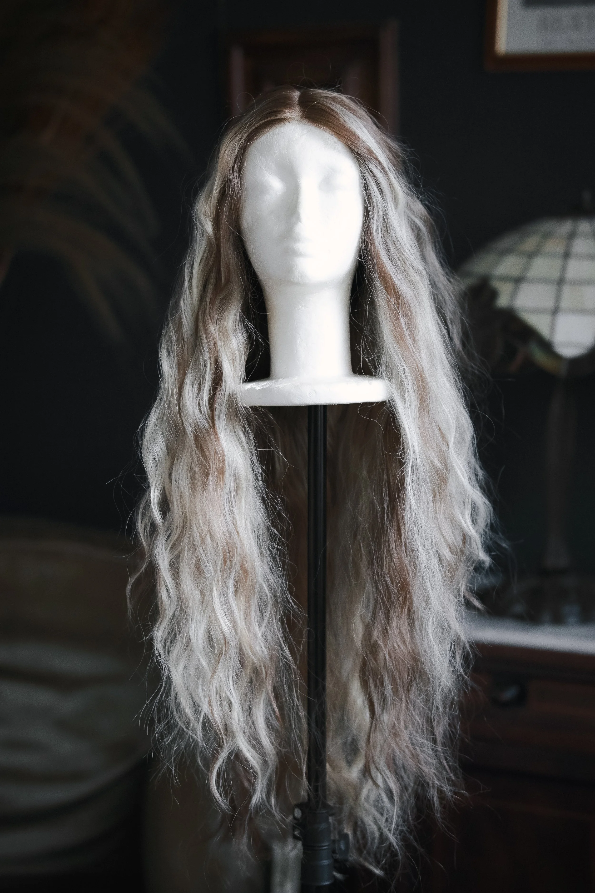 Long wavy blonde wig on a mannequin head