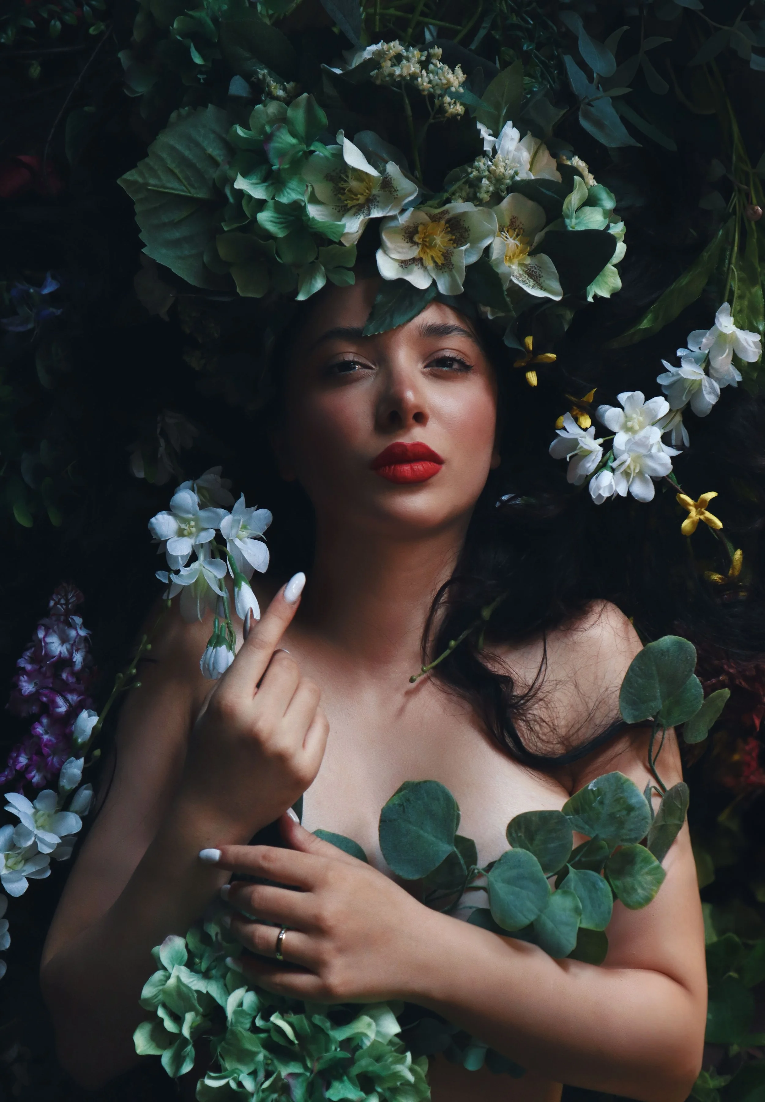 Woman with floral headpiece and foliage, artistic portrait
